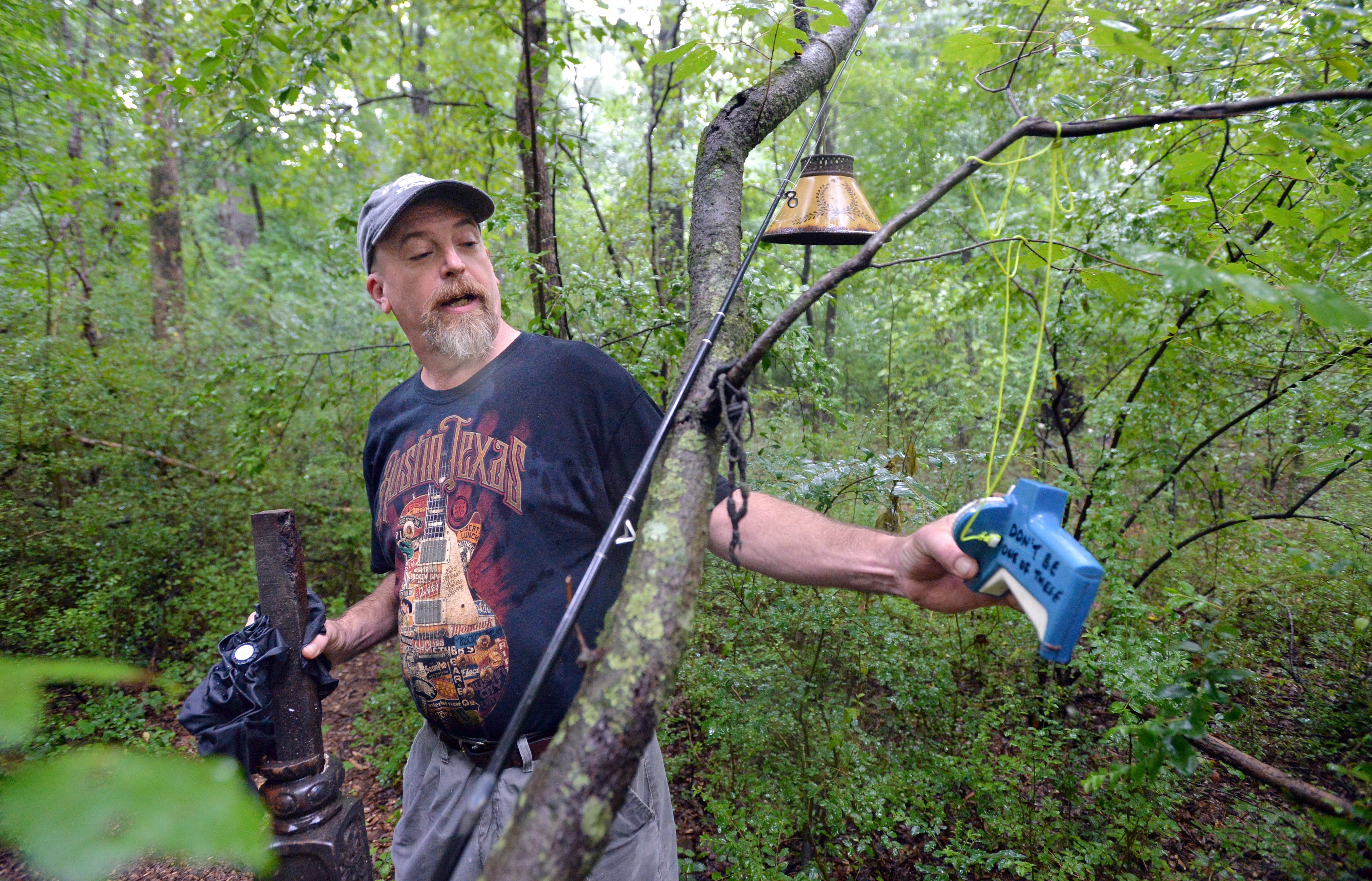 July 19, 2014 Atlanta - Joel Slaton shows off one of "found art" pieces at Dolls Head Trail on Saturday, July 19, 2014. Personal Journey on Joel Slaton, a carpenter who dealt with being underemployed about three years ago by wandering through on Constitution Lakes Park in Southwest DeKalb. He started picking up garbage that had been dumped off there for years and created a series of whimsical and creepy "found art" pieces, along a literally off-the-beaten path area he dubbed "Dolls Head Trail." The park itself has only existed for about five years -- it's in an industrial area, on the site of what was once an old brickworks plant and near the old prison farm. HYOSUB SHIN / HSHIN@AJC.COM