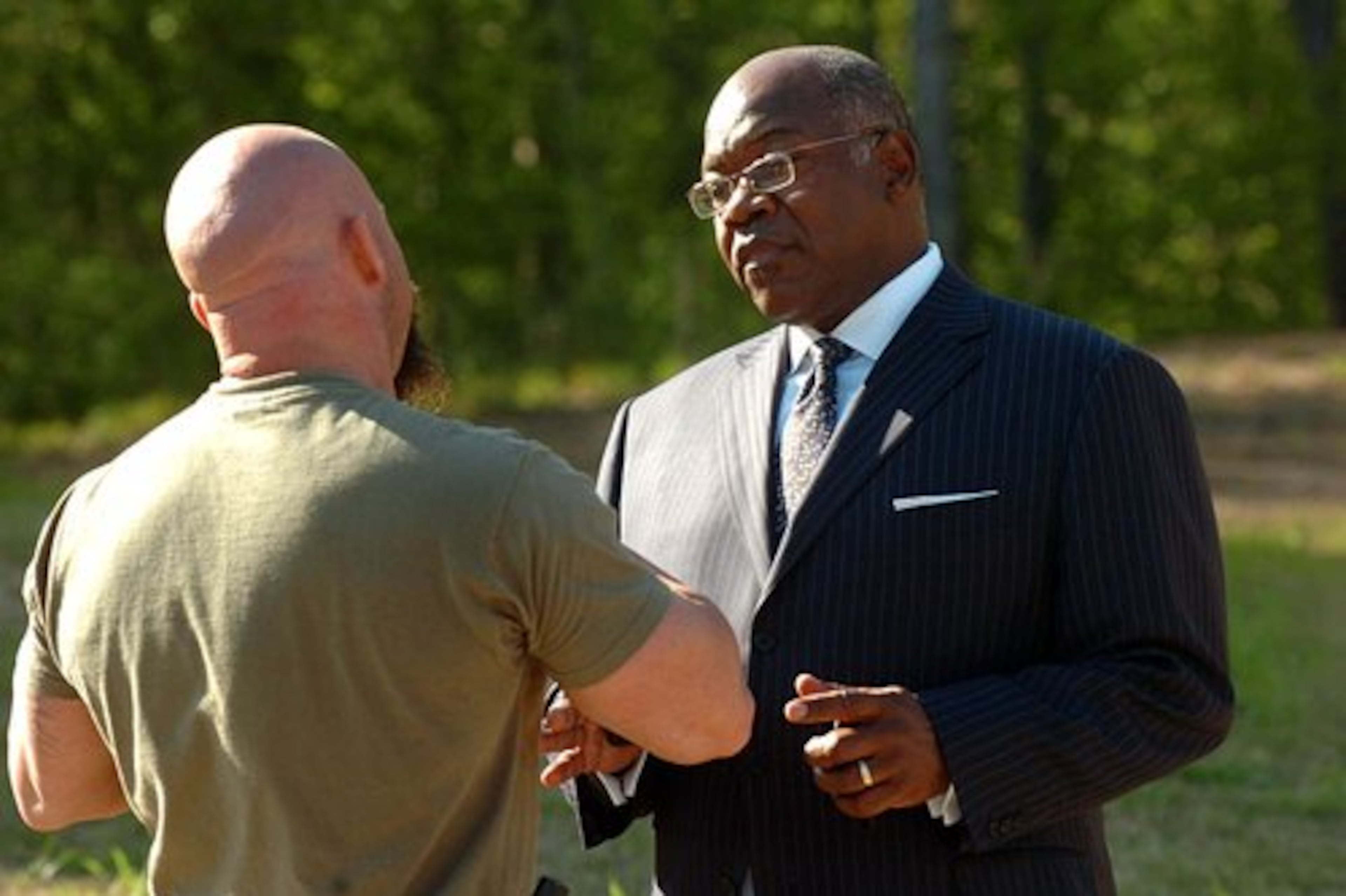 Thomas Cuffie, attorney representing Kathy Smith, mother of the late Delisia Carter, talks with a Fulton County police officer at 3915 Ailey Ave.