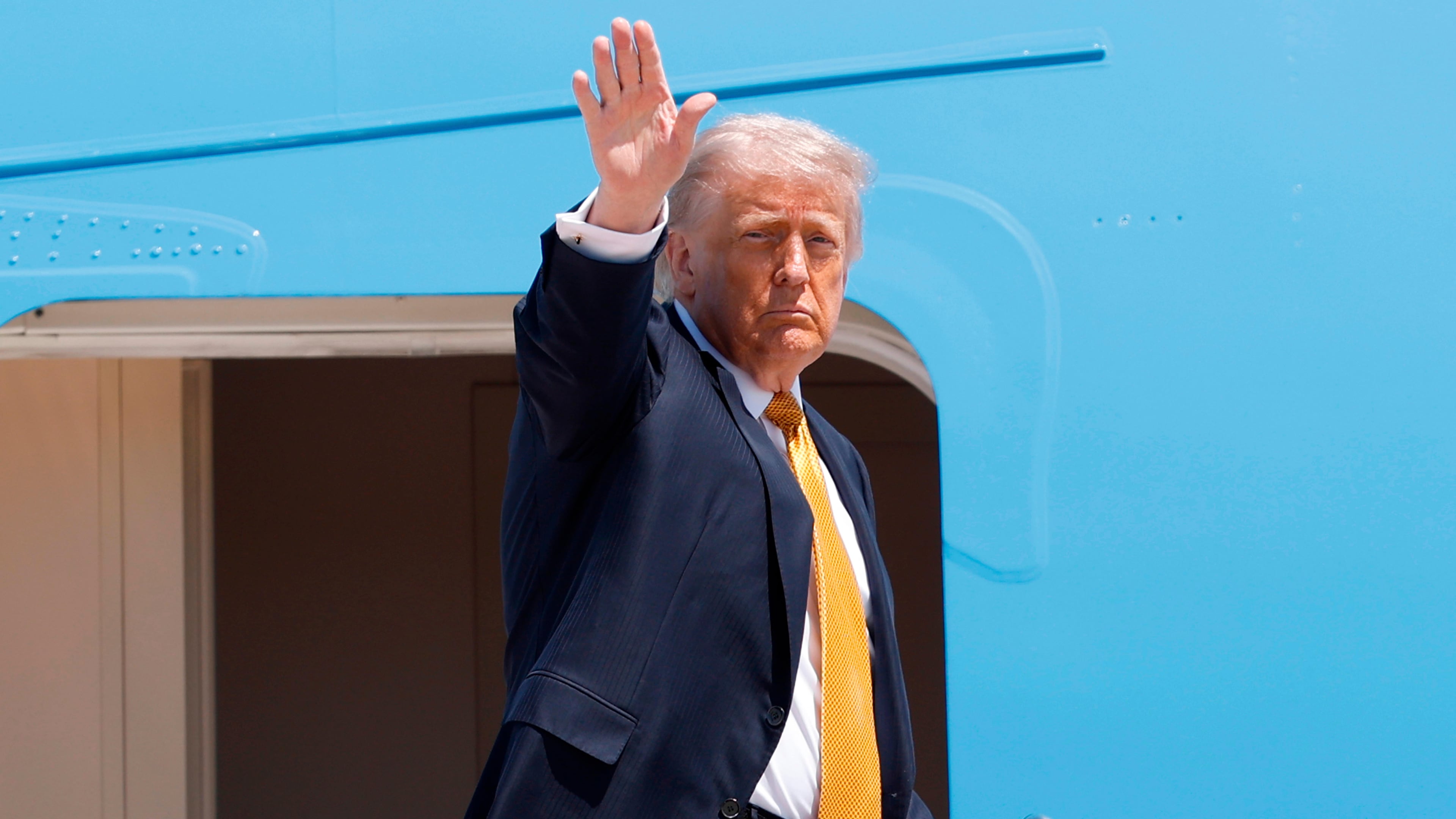 President Donald Trump waves from the stairs of Air Force One as he boards upon his arrival at Joint Base Andrews, Md., Tuesday, May 12, 2026, for a trip to China to meet President Xi Jinping. (AP Photo/Luis M. Alvarez)