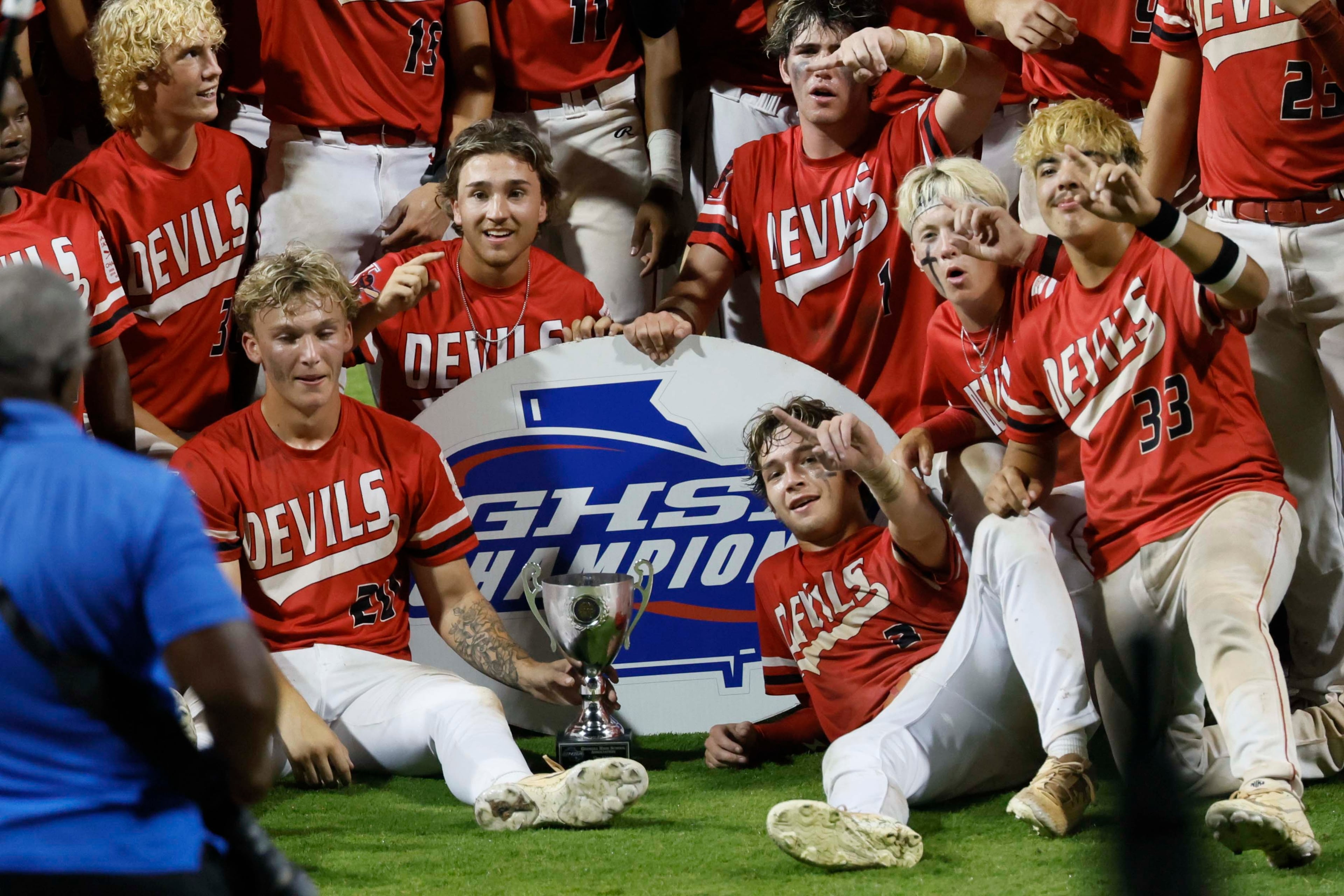 Loganville players take a photo after winning 4-3 against Pope in Game 3 of the Class 5A GHSA Baseball State Championship Series at Gwinnett Field on Tuesday, May 26, 2026, in Lawrenceville. Loganville’s Brantley Carter (2) points with his finger after being named MVP following his walk-off hit. (Miguel Martinez/AJC)