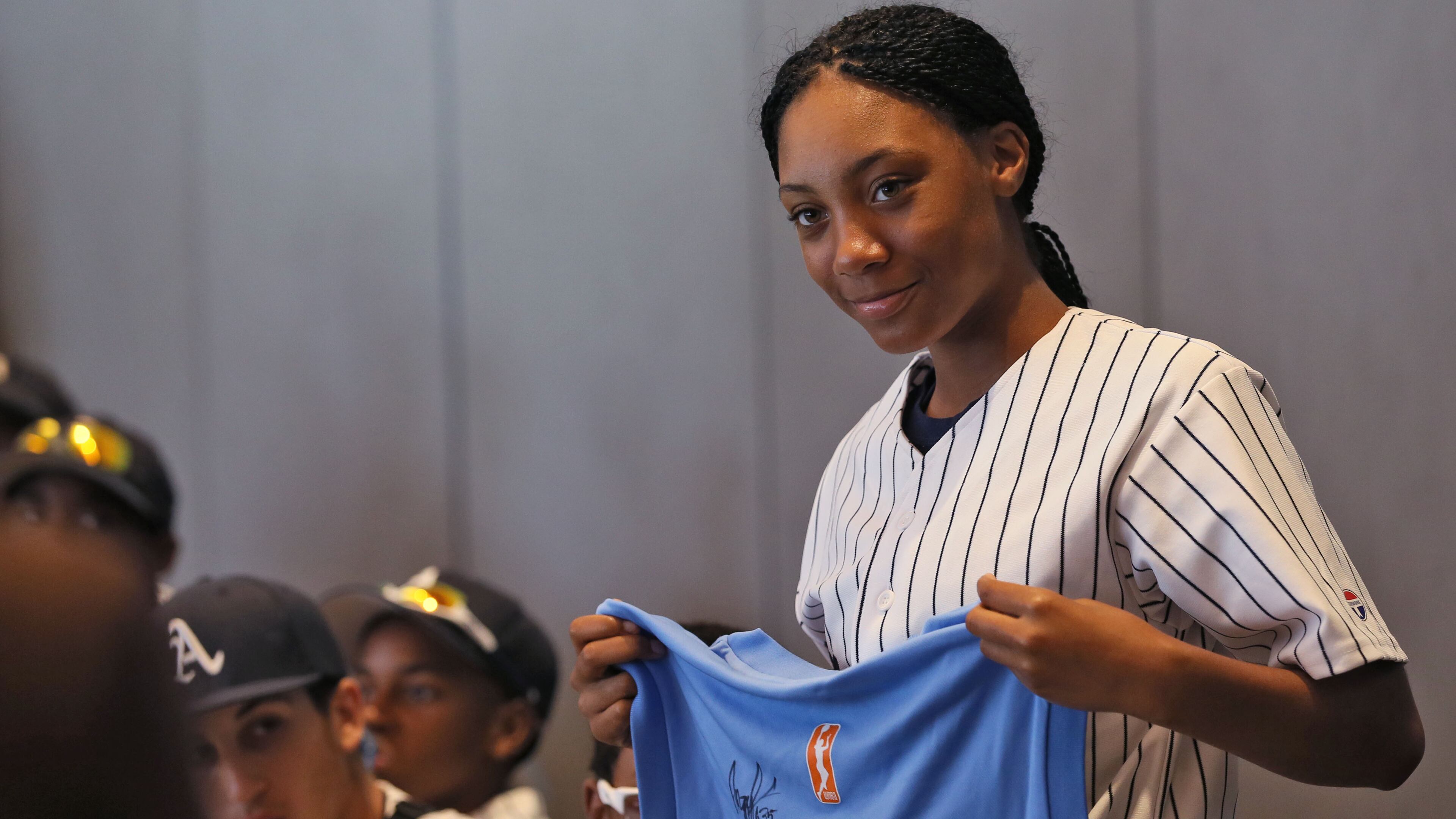 Mo'ne Davis receives a jersey from Atlanta Dream GM Angela Taylor, during the Anderson Monarchs' 23-day civil rights tour that made a stop in Atlanta in June 2015.
