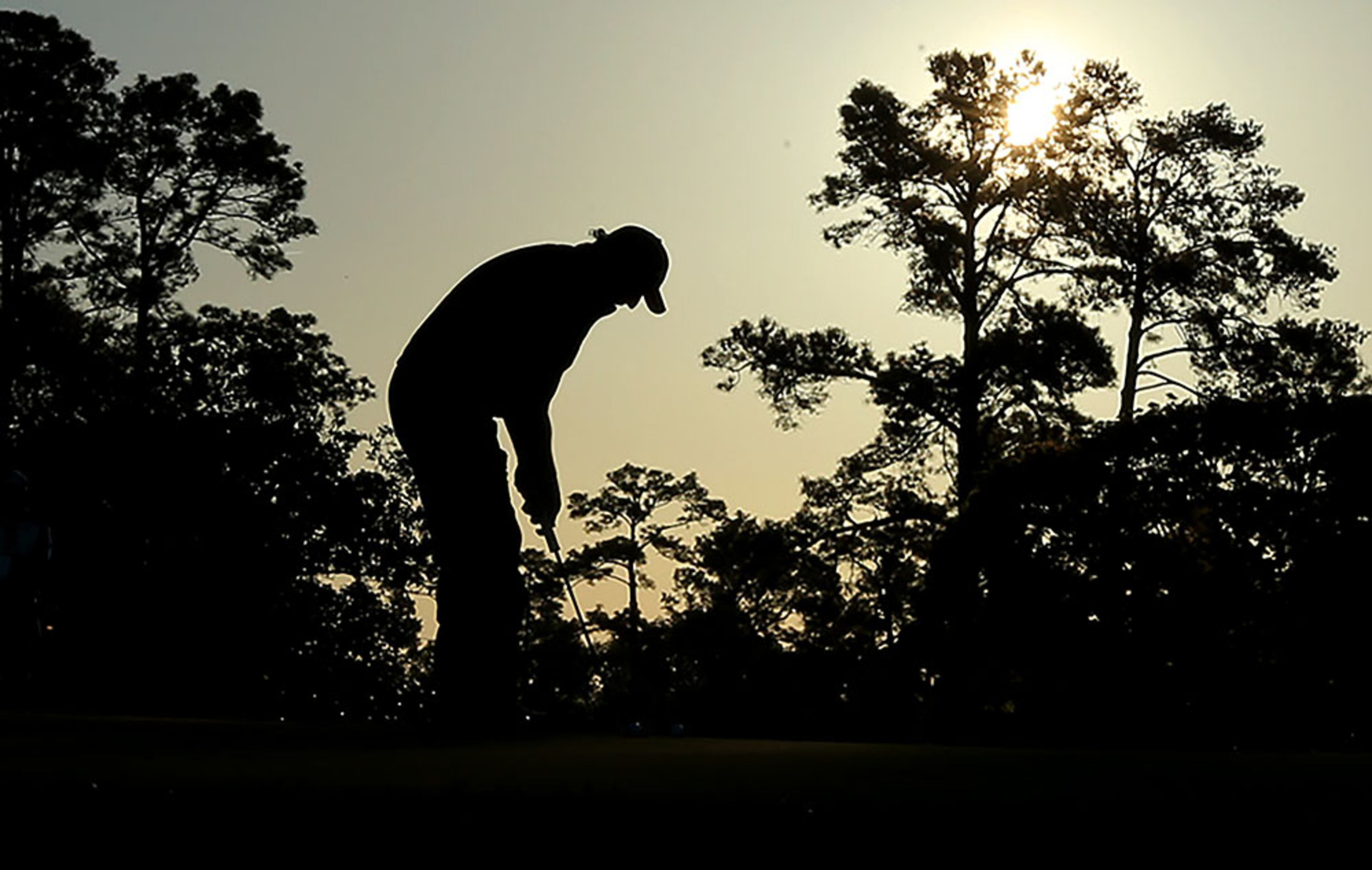 Phil Mickelson is on the practice putting green at sunrise just before teeing off to begin his practice round for the Masters at Augusta National Golf Club on Tuesday, April 5, 2016, in Augusta.