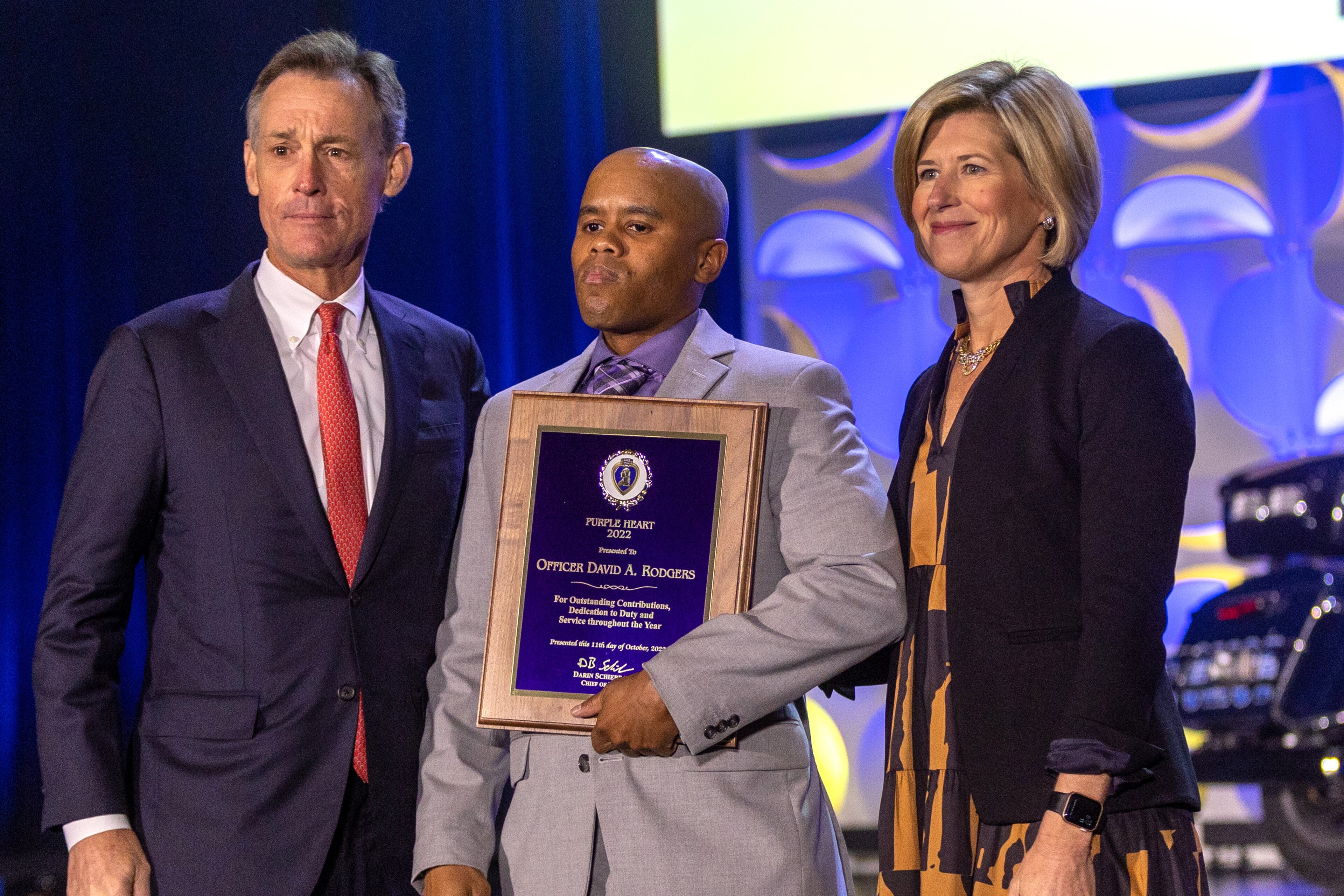 Officer David A. Rodgers (center) accepts his Purple Heart 2022 award during the 18th Annual Crime Is Toast 2022 awards breakfast at the World Congress Center Thursday, Oct. 11, 2022. Steve Schaefer/steve.schaefer@ajc.com)