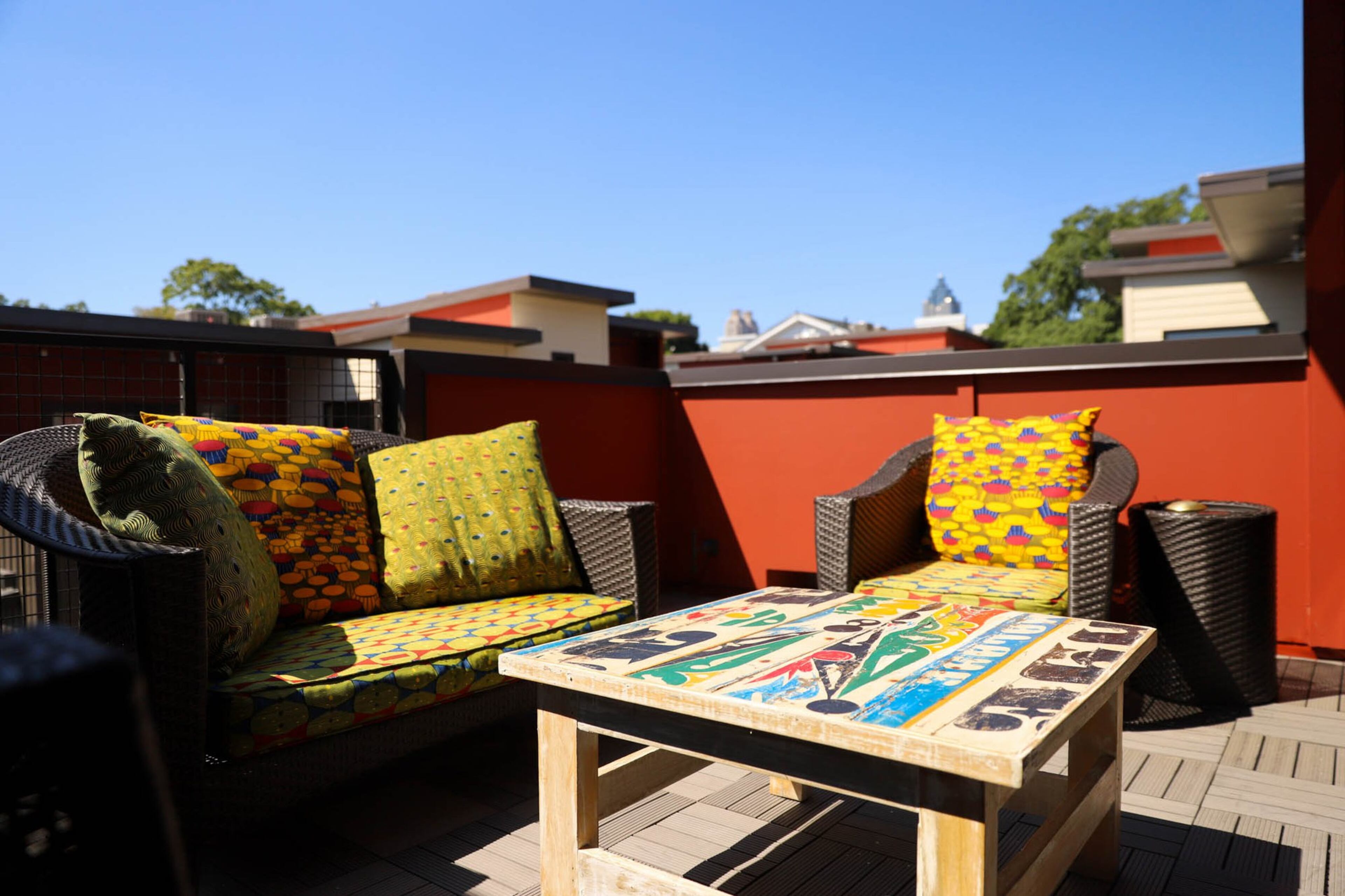 Furniture from Target sits on Jumbe and Anja Sebunya’s deck. The couple had the furniture reupholstered in Dakar, Senegal, using tradtional Dutch wax fabric. The coffee table comes from Artlantique, also in Dakar Senegal. Text by Shannon Dominy. Photo by Reynolds Rogers.