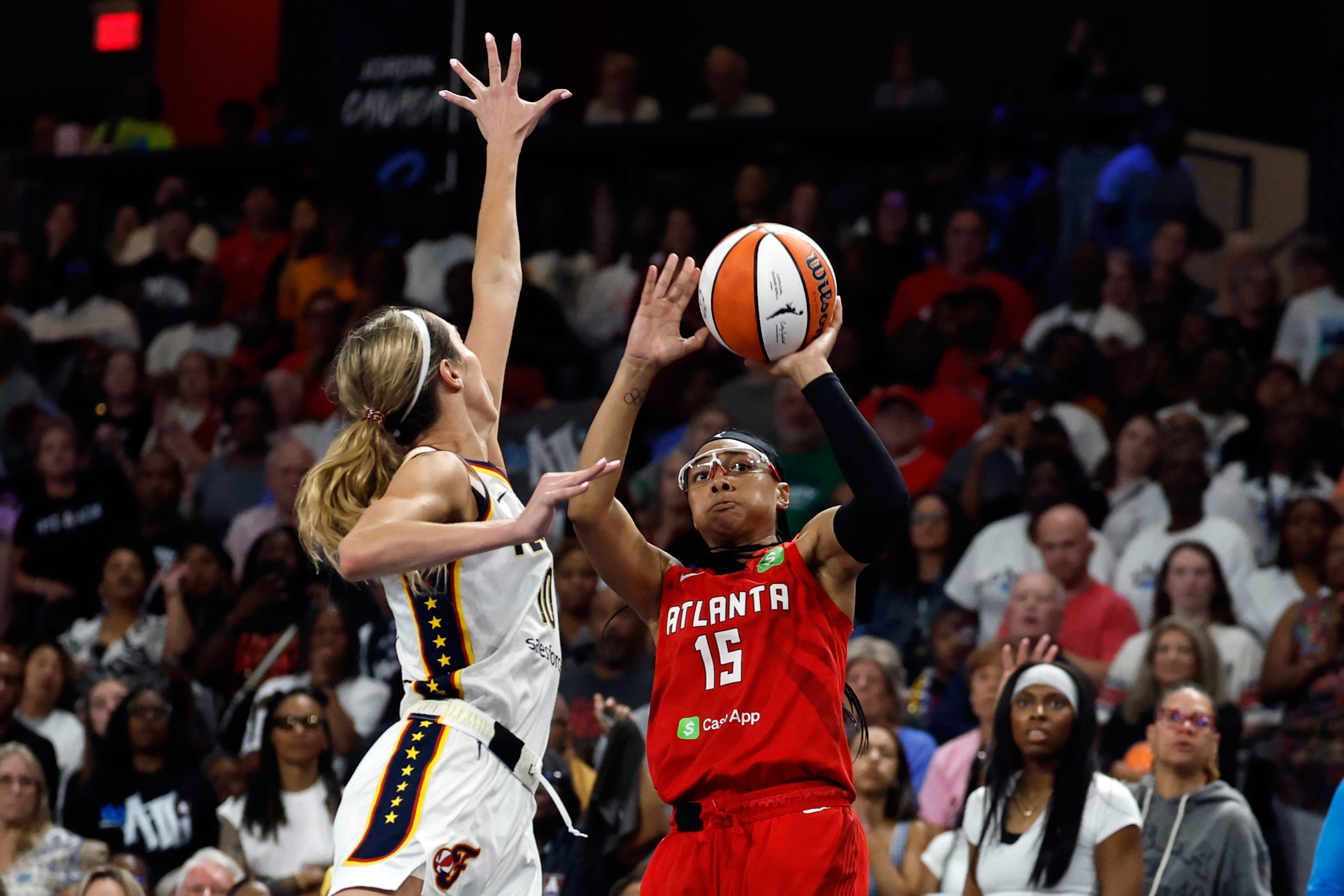Atlanta Dream guard Allisha Gray (15) looks to shoot as Indiana Fever guard Lexie Hull, left, defends during the second half of Game 3 in the first round of the WNBA basketball playoffs, Thursday, Sept. 18, 2025, in Atlanta. (AP Photo/Butch Dill)