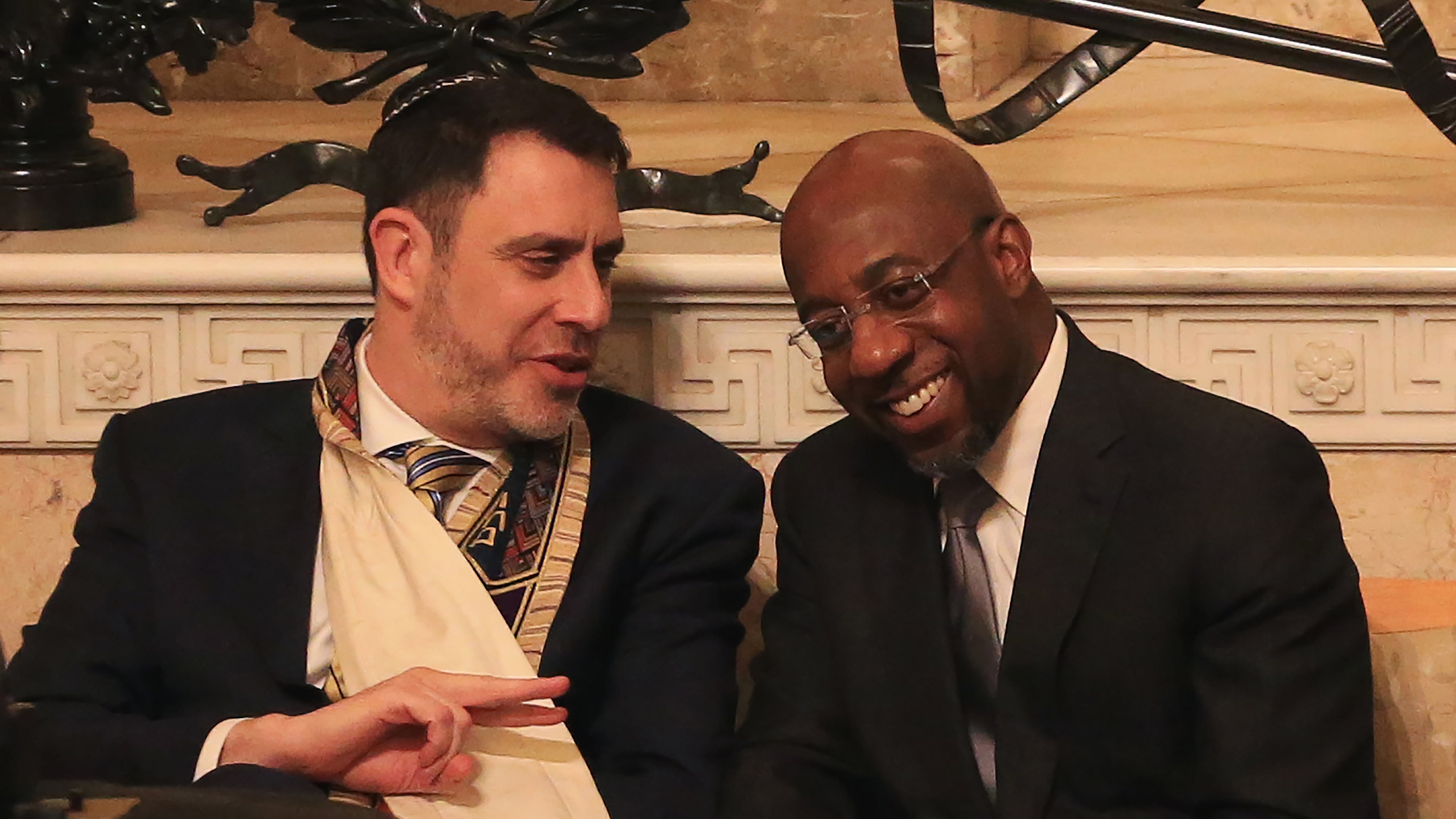Chief Rabbi Peter S. Berg (left) and Rev. Raphael G. Warnock talk during the joint Martin Luther King Jr. Shabbat service on Friday, Jan. 17, 2020, at The Temple in Atlanta. Each year the congregations from The Temple and Ebenezer Baptist Church join for a Shabbat service to honor Martin Luther King Jr. as a symbol of the Black and Jewish alliance in Atlanta. (Christina Matacotta for the AJC)