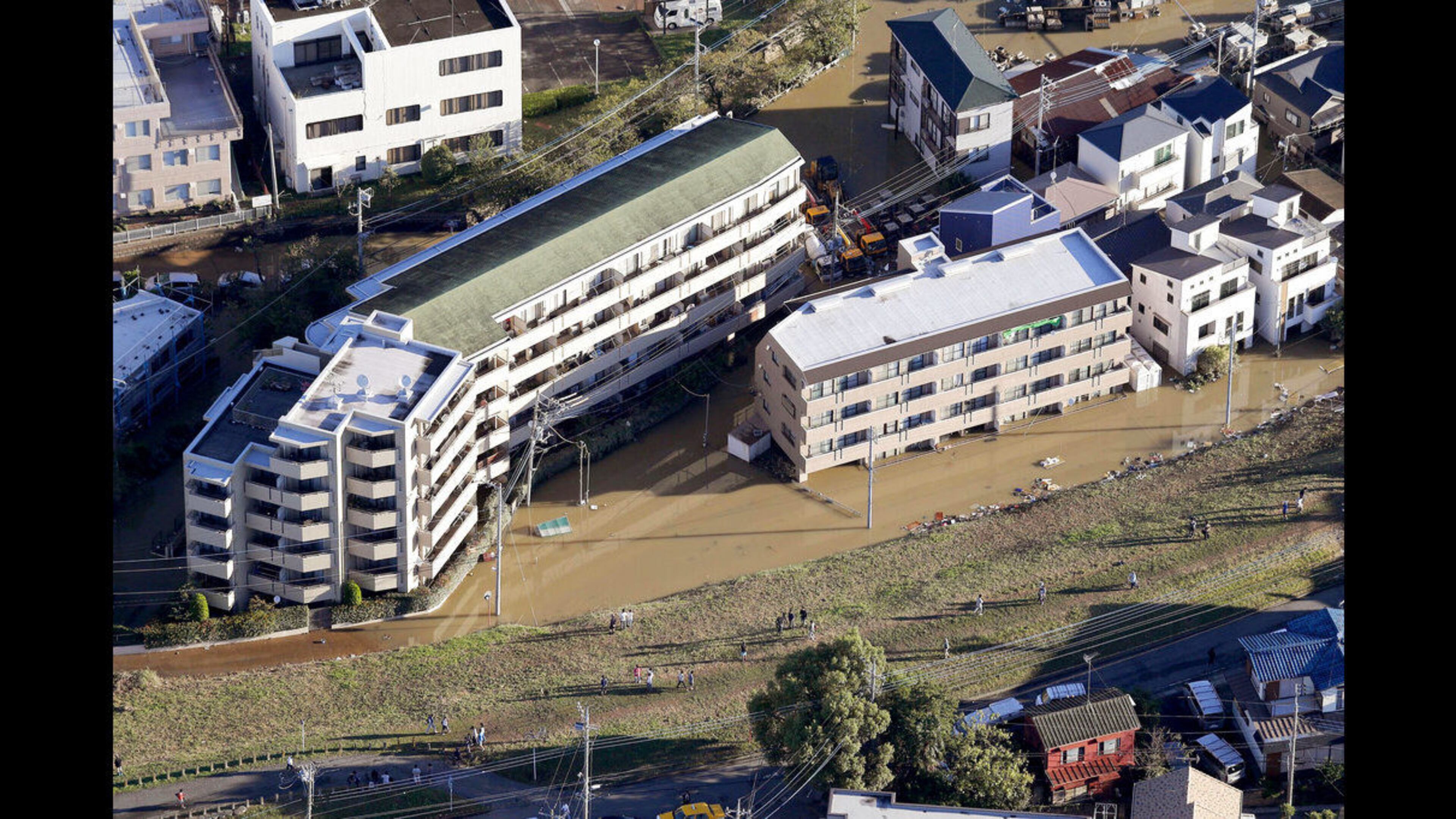 Houses are submerged in muddy waters as Typhoon Hagibis hit the area, in Kawagoe, north of Tokyo, Sunday, Oct. 13, 2019.