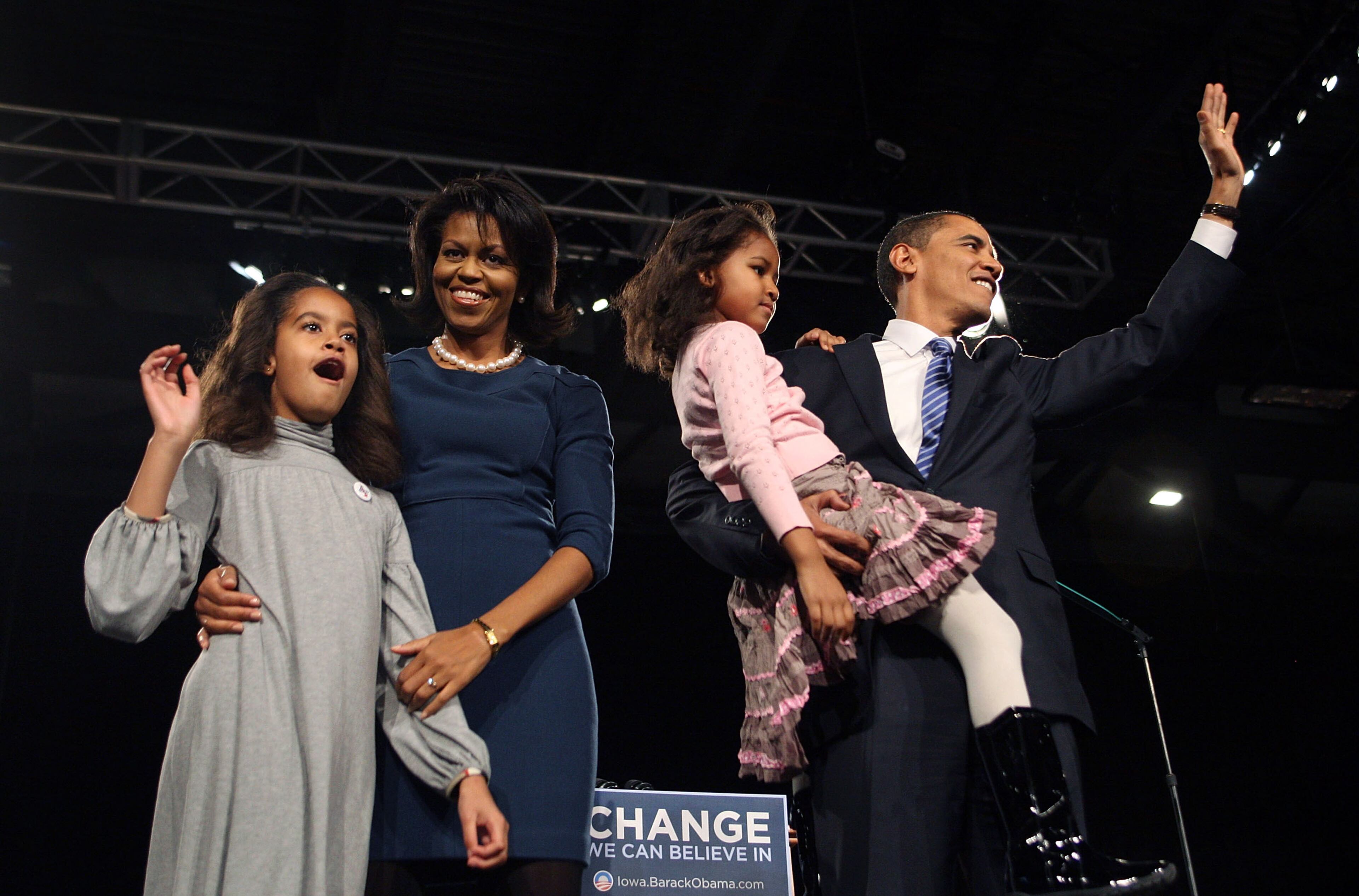 Democratic Presidential hopeful Senator Barack Obama (D-IL) (R) his wife Michelle, and daughters Malia (L) and Sasha greet supporters gathered for a post-caucus celebration at the Hy-Vee Center January 3, 2008 in Des Moines, Iowa. According to reports Obama has won the Democratic caucus race in Iowa and will now move his campaign for the American presidency to New Hampshire which holds its primary next week. (Photo by Scott Olson/Getty Images)