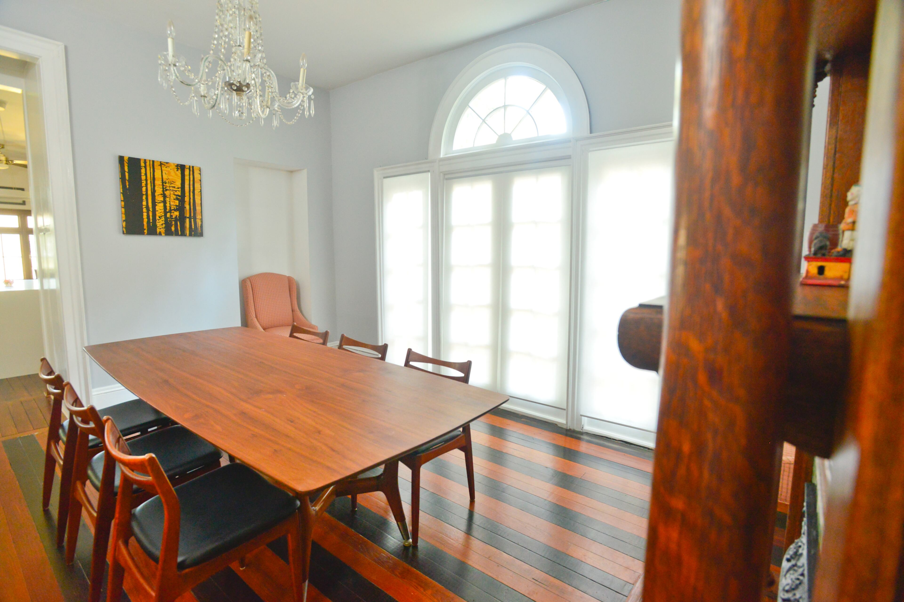 The walnut dining table from City Issue is the homeowners' favorite piece of furniture and started their love for mid-century modern design. They loved the look of the wood so much that they selected walnut for the cabinets when they renovated the kitchen of the Inman Park home.