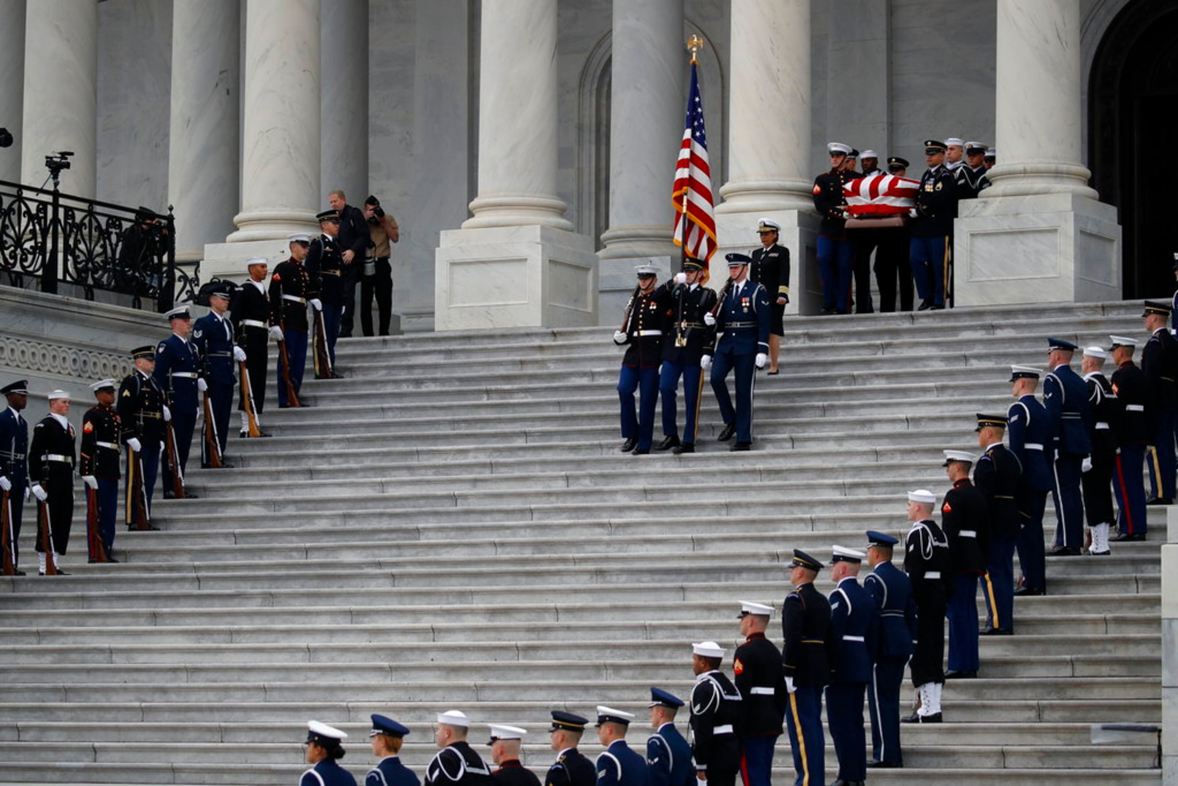 The flag-draped casket of former President George H.W. Bush is carried by a joint services military honor guard from the U.S. Capitol, Wednesday, Dec. 5, 2018, in Washington. (AP Photo/Alex Brandon, Pool)