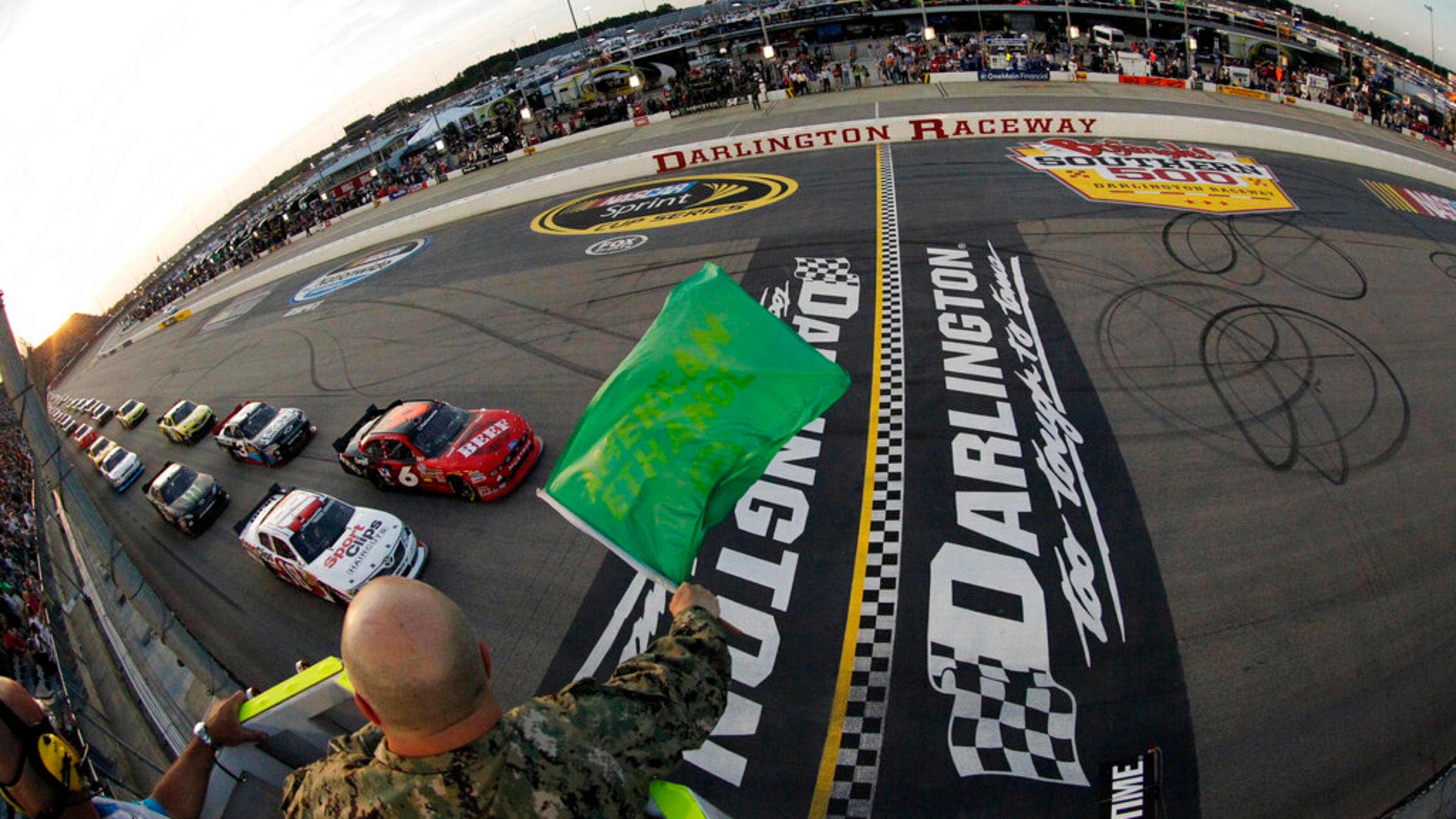In this May 11, 2012, file photo, drivers take the green flag for the start of the NASCAR Nationwide Series auto race at Darlington Raceway in Darlington, S.C. NASCAR will re-fire the engines moments after mask-clad drivers climb into their cars at Darlington Raceway. The season will resume Sunday May 17, 2020, without spectators and drivers will have no practice before they pull away from pit road for the first time in more than two months. (Tyler Barrick/Pool Photo via AP, File)