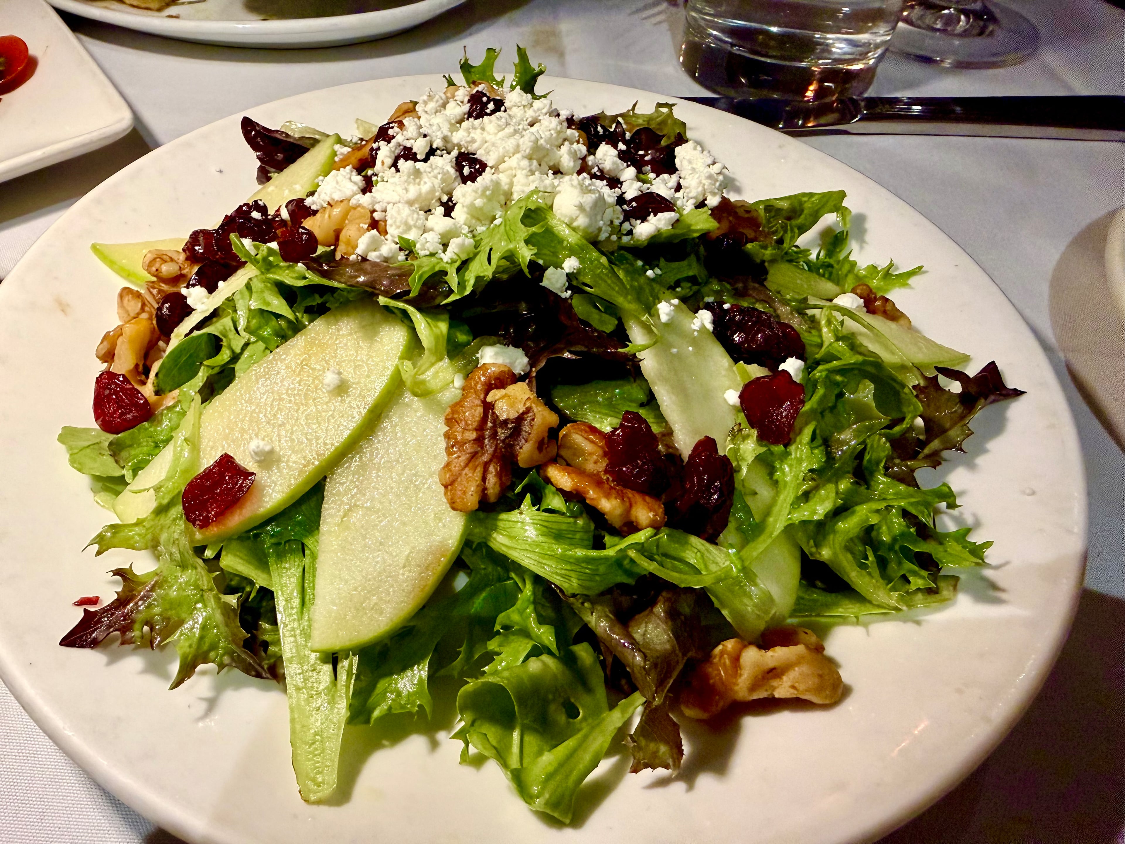 Green apple and toasted walnuts bring crunch to the insalata di stagione at Sandy Springs's il Giallo Osteria & Bar. (Angela Hansberger for the AJC)