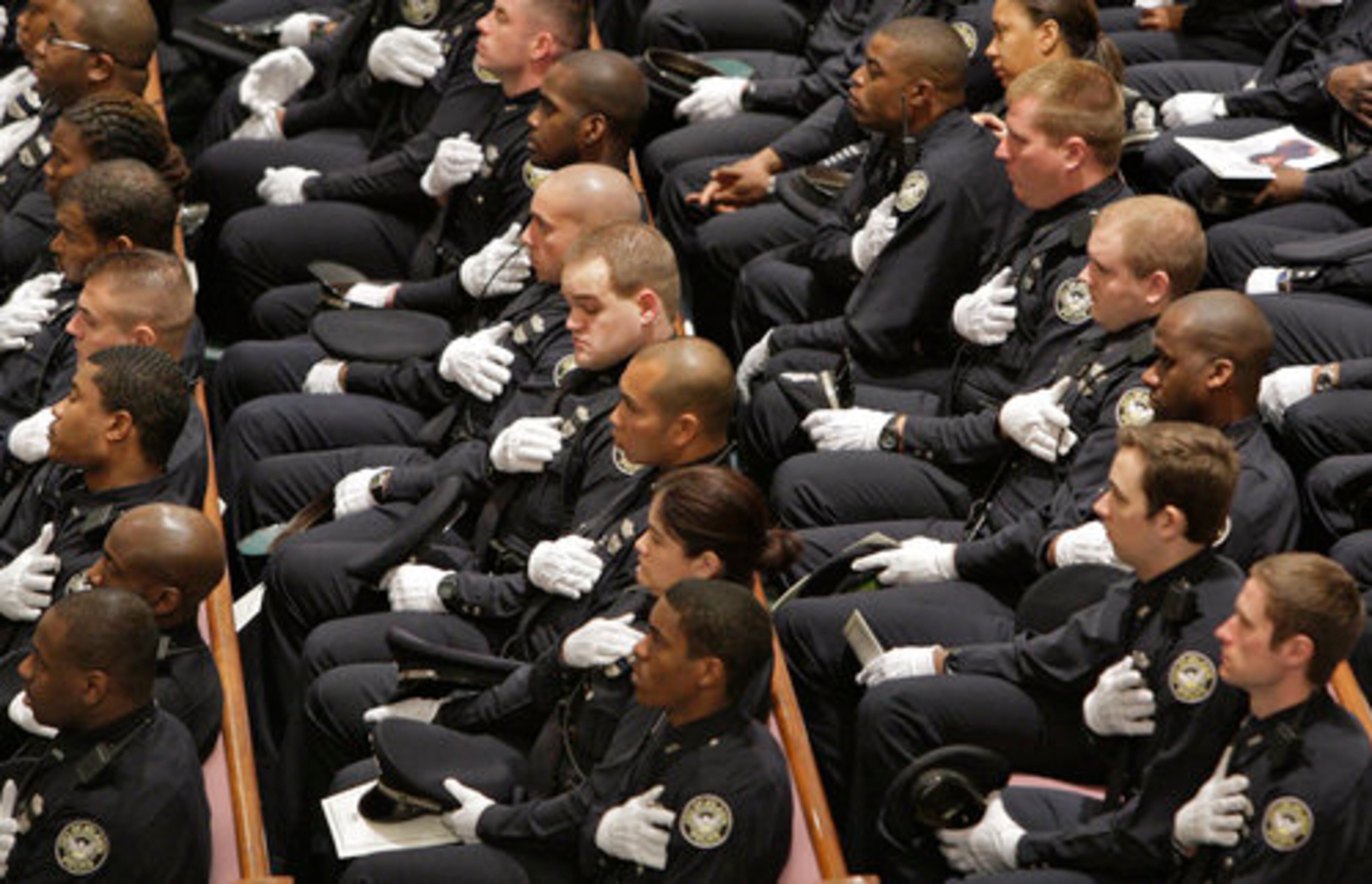 Police officers from throughout the area listen to tributes to the fallen officer. The standing room only funeral for Senior Police Officer Gail Thomas was held at Elizabeth Baptist Church in Atlanta. A police procession led by motorcycle patrol entered the church grounds beneath a giant American flag suspended by fire ladder trucks, and police units from throughout the area processed into the church.