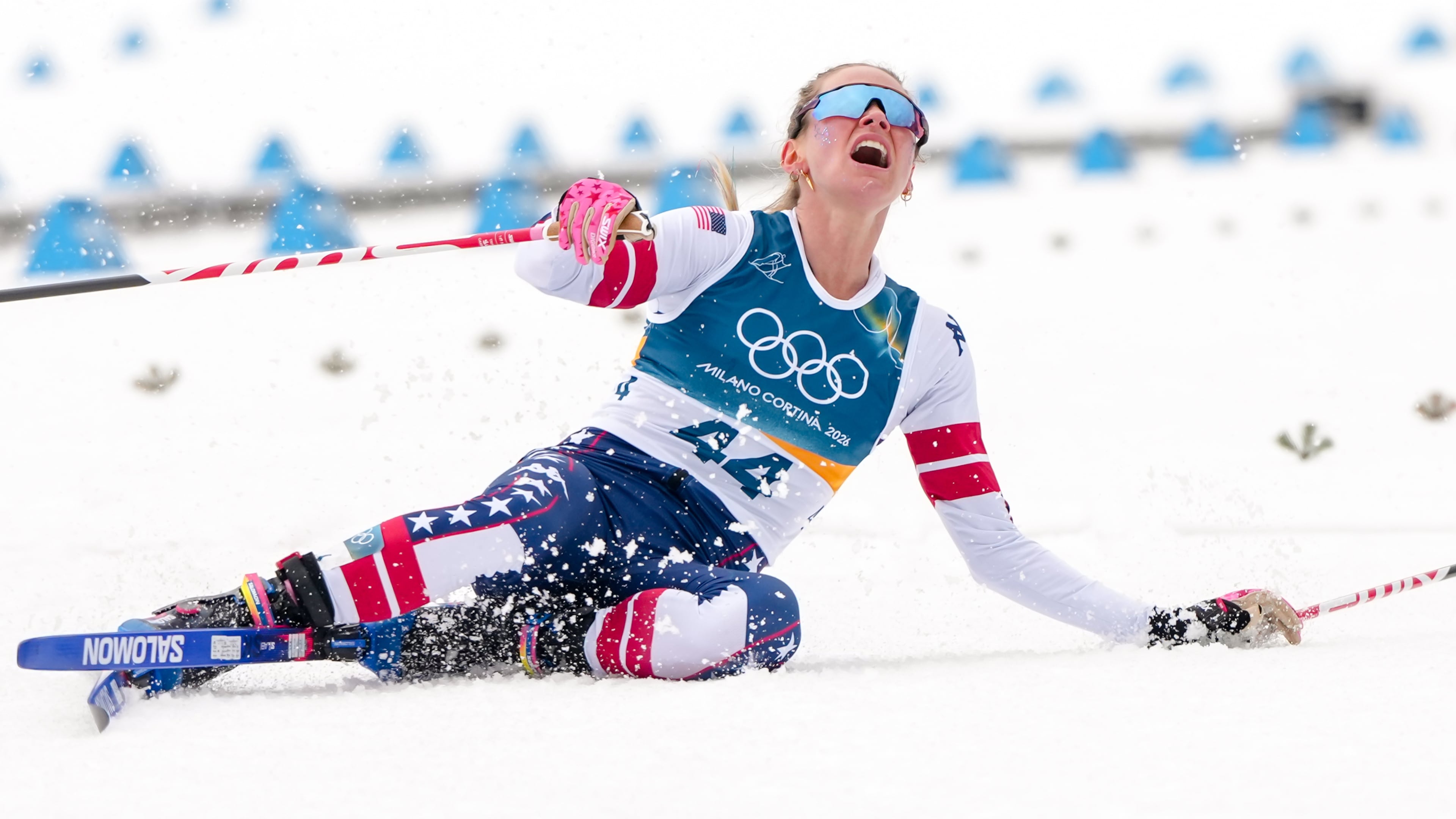 Jessie Diggins, of the United States, falls to the ground after crossing the finish line in the cross country skiing women's 10km interval start free at the 2026 Winter Olympics, in Tesero, Italy, Thursday, Feb. 12, 2026. (AP Photo/Kirsty Wigglesworth)