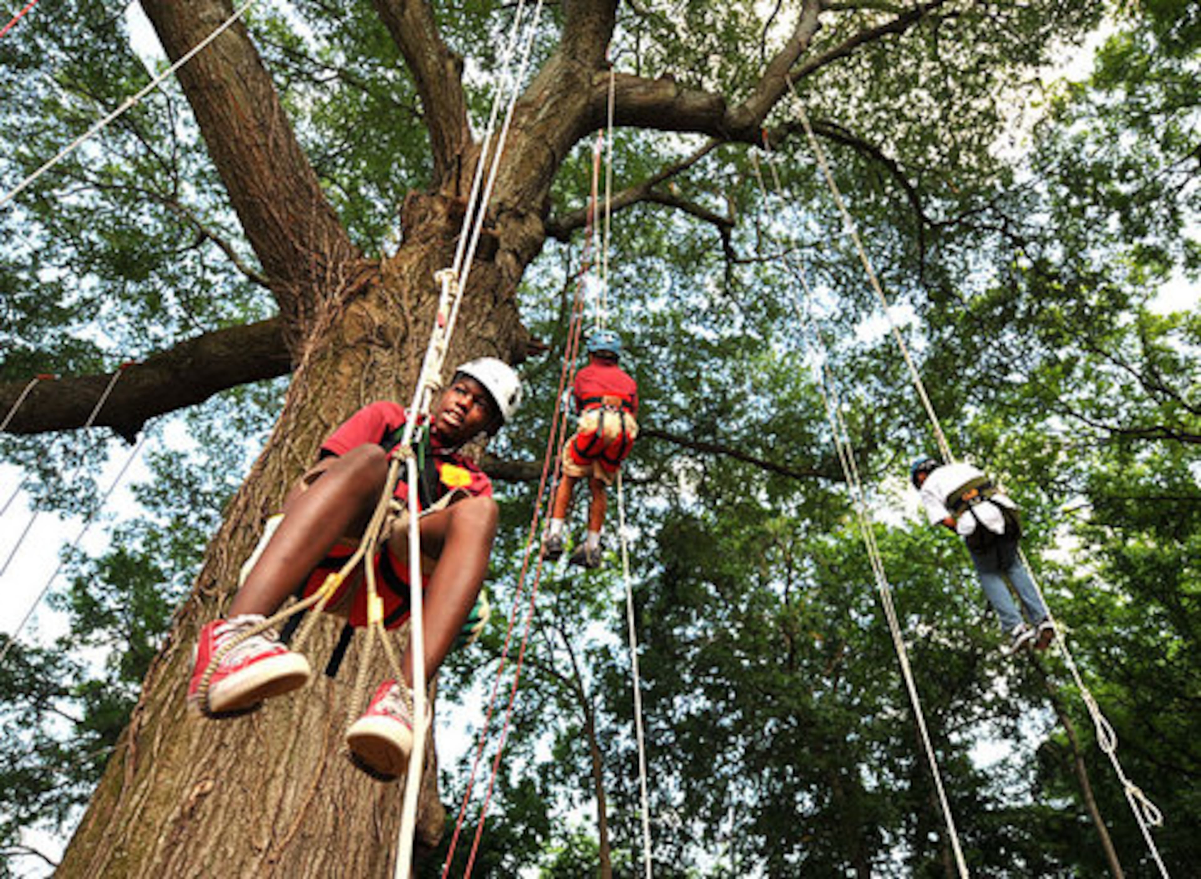 KeDarius Weaver hangs out for a few minutes as he takes a break from climbing a tree. Members of Tree Climbers International taught tree climbing skills to middle school students May 24, 2010.