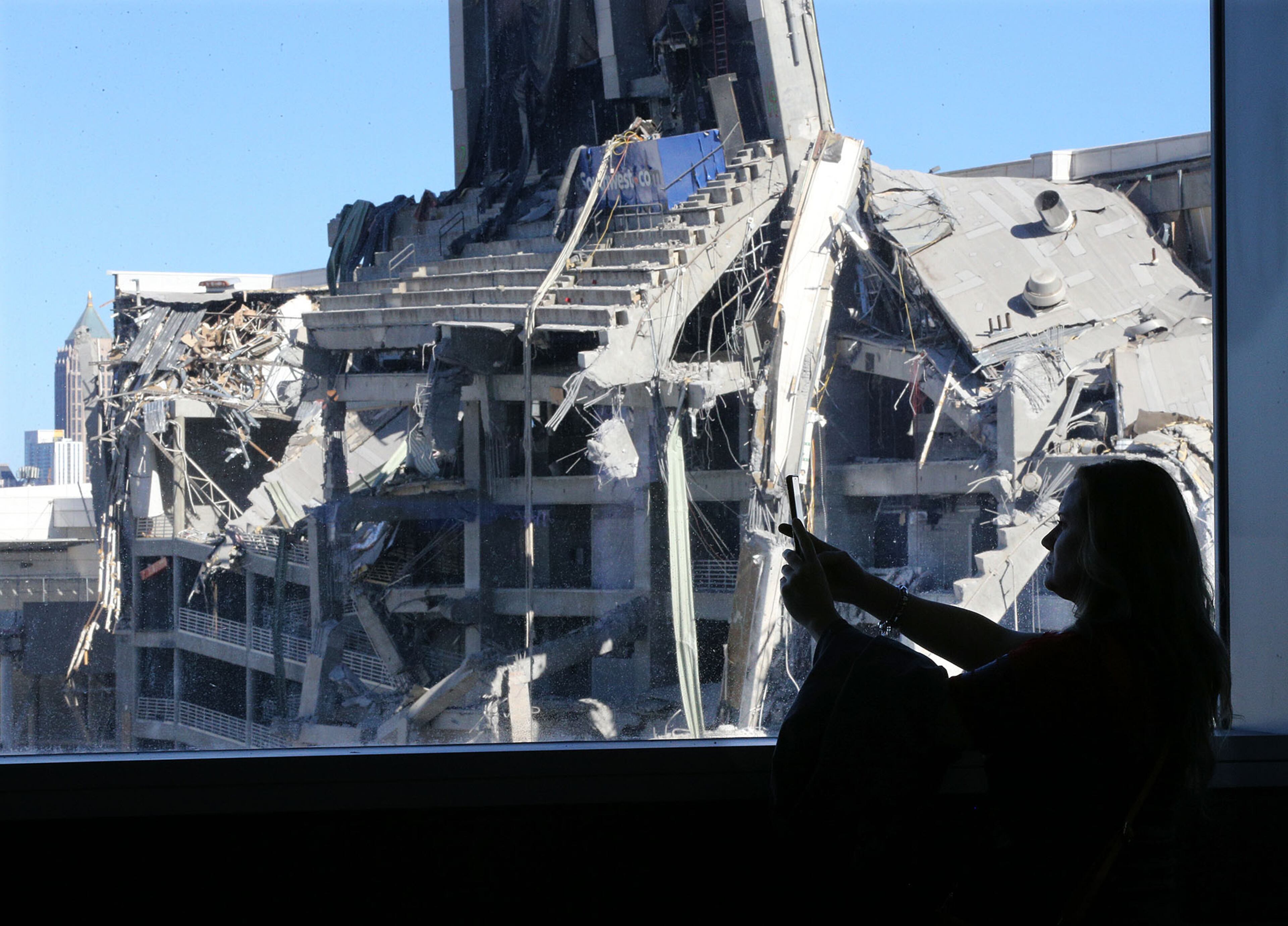 Atlanta: Falcons fan Melanie Inabinet makes a video of the remains of the Georgia Dome from inside Mercedes-Benz stadium. The Georgia Dome was imploded last year. Curtis Compton/ccompton@ajc.com