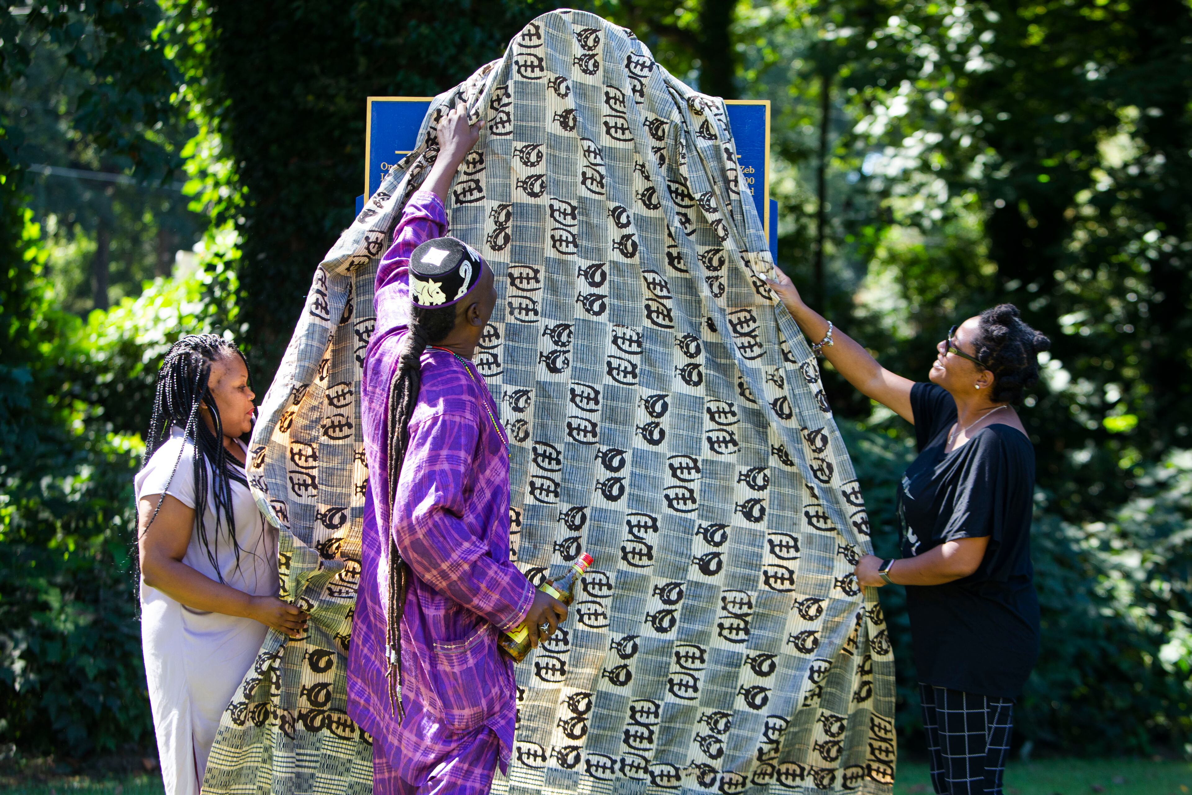 Ann Hill-Bond (from left), Christopher Swain and Deana Holiday Ingraham unveil the historical marker for Zeb Long, a lynching victim from the 1906 Atlanta Race Massacre, on Saturday, September 24, 2022, at Sumner Park in East Point. The event was held by the Fulton County Remembrance Coalition. CHRISTINA MATACOTTA FOR THE ATLANTA JOURNAL-CONSTITUTION