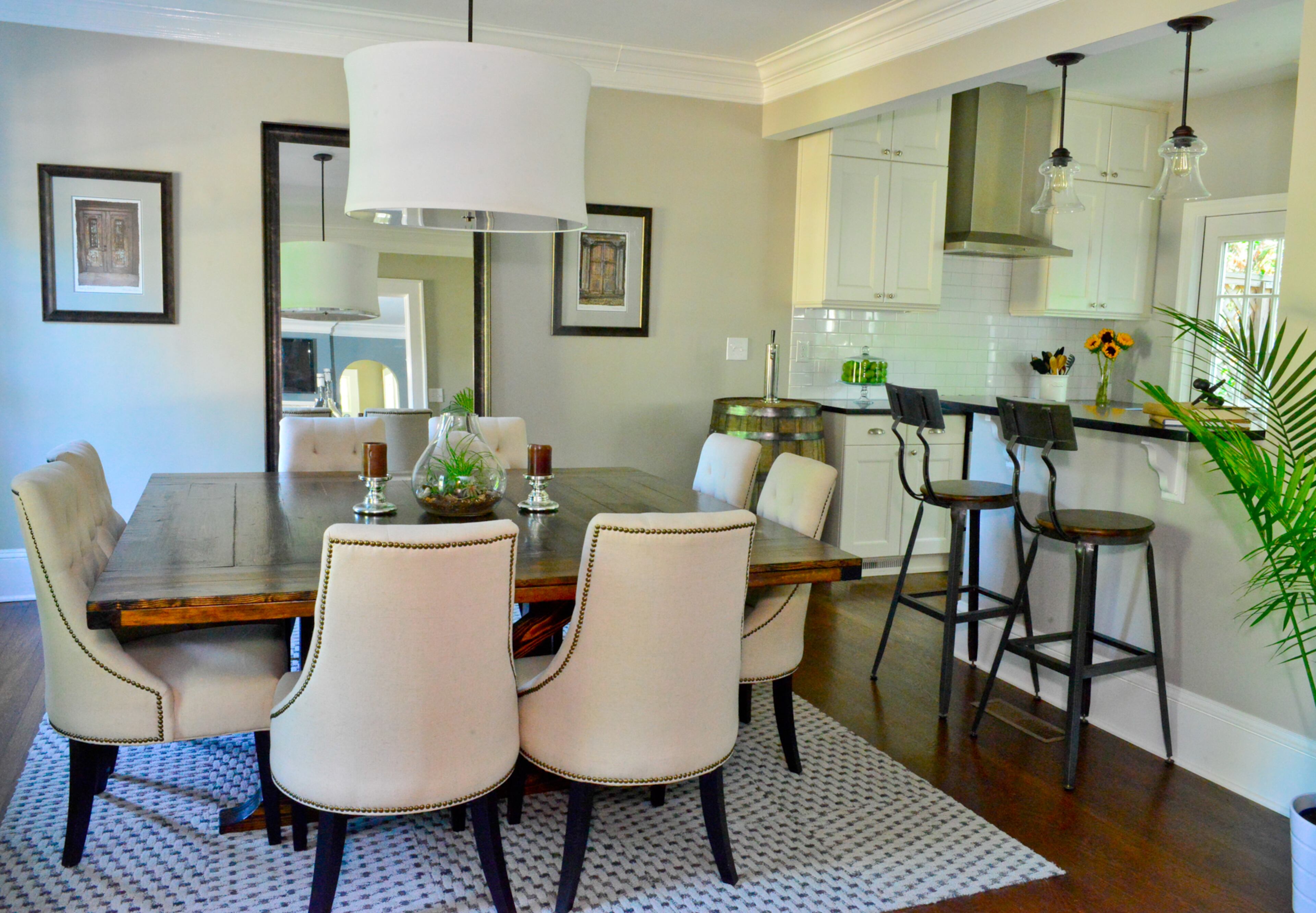 A wall was removed in between the dining room and the old galley-style kitchen, which was remodeled and now includes a breakfast bar. The dining room, kitchen and living area were renovated over six weeks by John Rogers Renovations and filmed for HGTV's "Property Brothers."