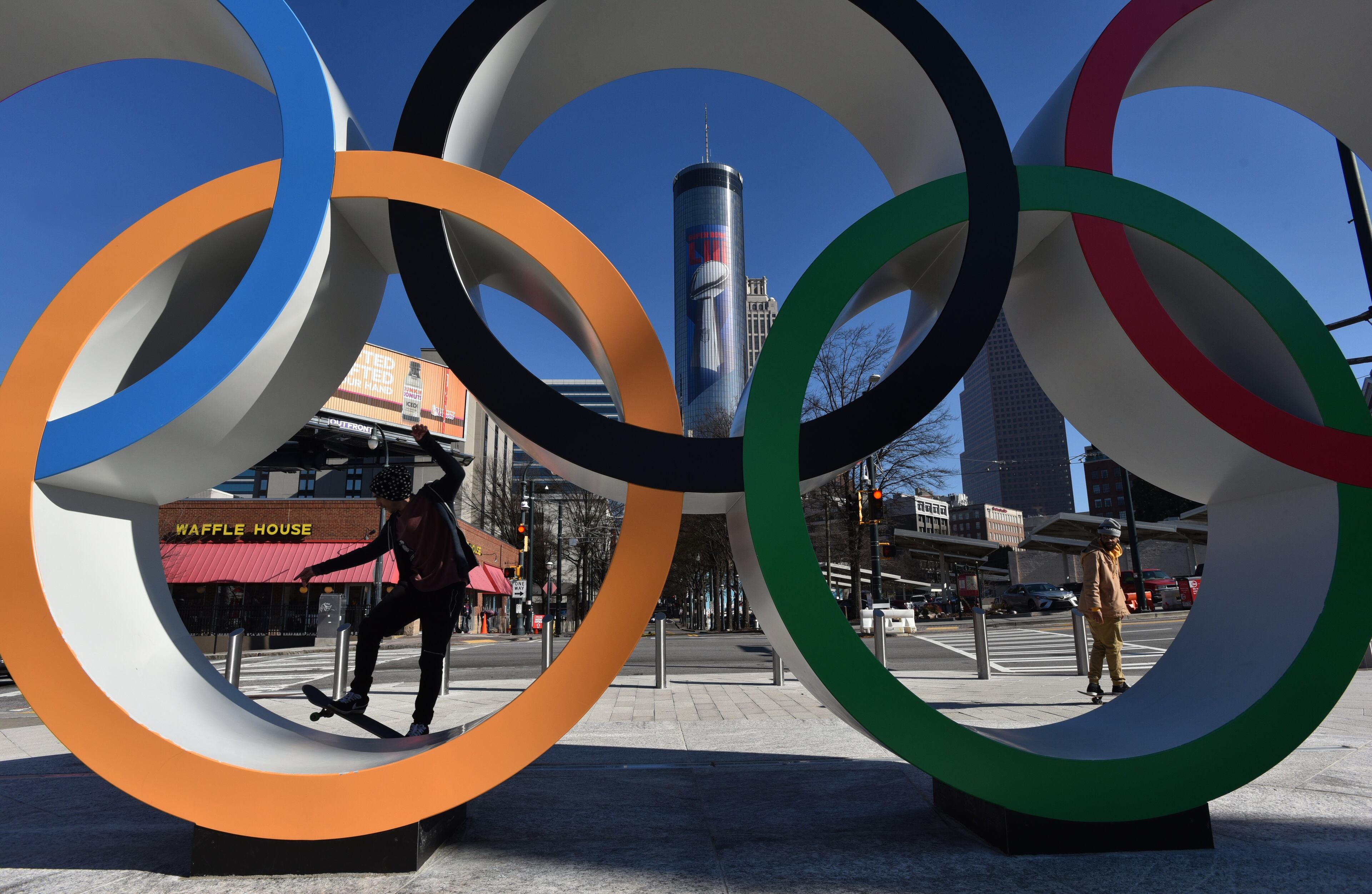 January 16, 2019 Atlanta - Skateboarders ride around Olympic Rings as The Westin Peachtree Plaza with Super Bowl signage is shown in background near Centennial Olympic Park in downtown Atlanta on Wednesday, January 16, 2019. Atlanta faces a test on Super Bowl Sunday and the question with less than a month to go before the big game is this: Is the city ready? The city budgeted some $10 million last year for police, fire and other items to assist with the big game. HYOSUB SHIN / HSHIN@AJC.COM