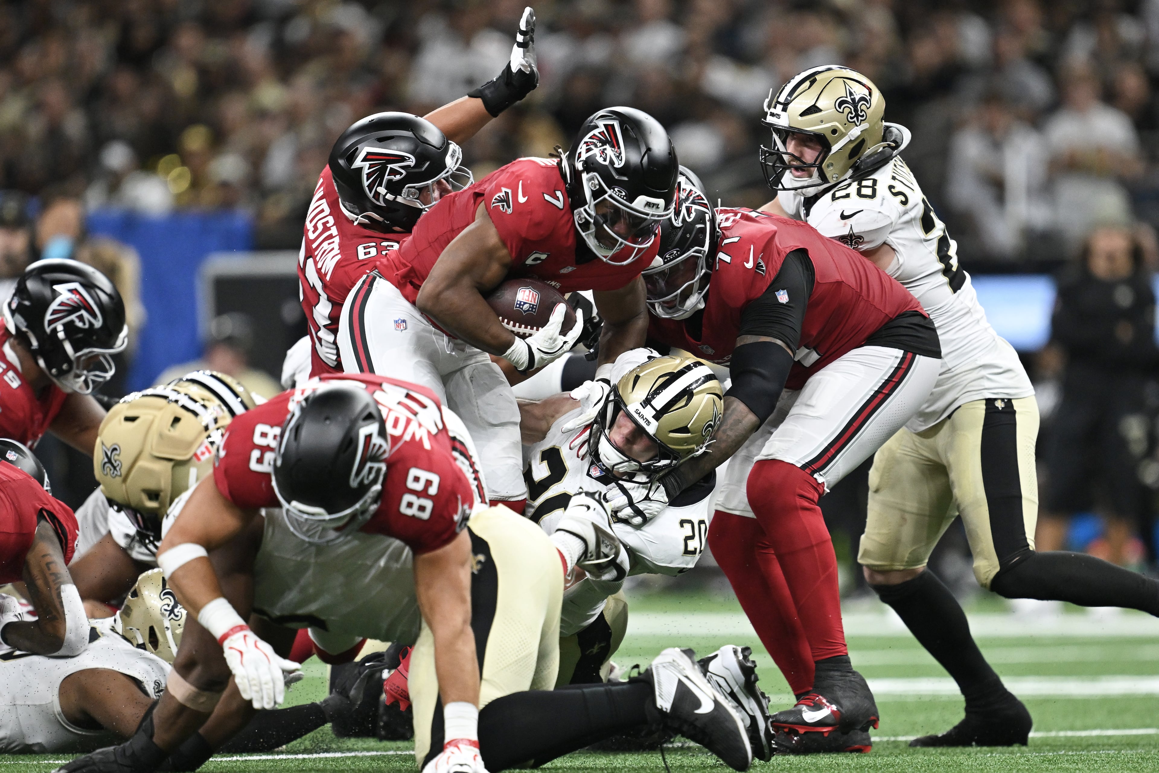 Atlanta Falcons running back Bijan Robinson (center) runs against the New Orleans Saints during the second half of an NFL football game in New Orleans, Monday, Oct. 5, 2026. (Ella Hall/AP)