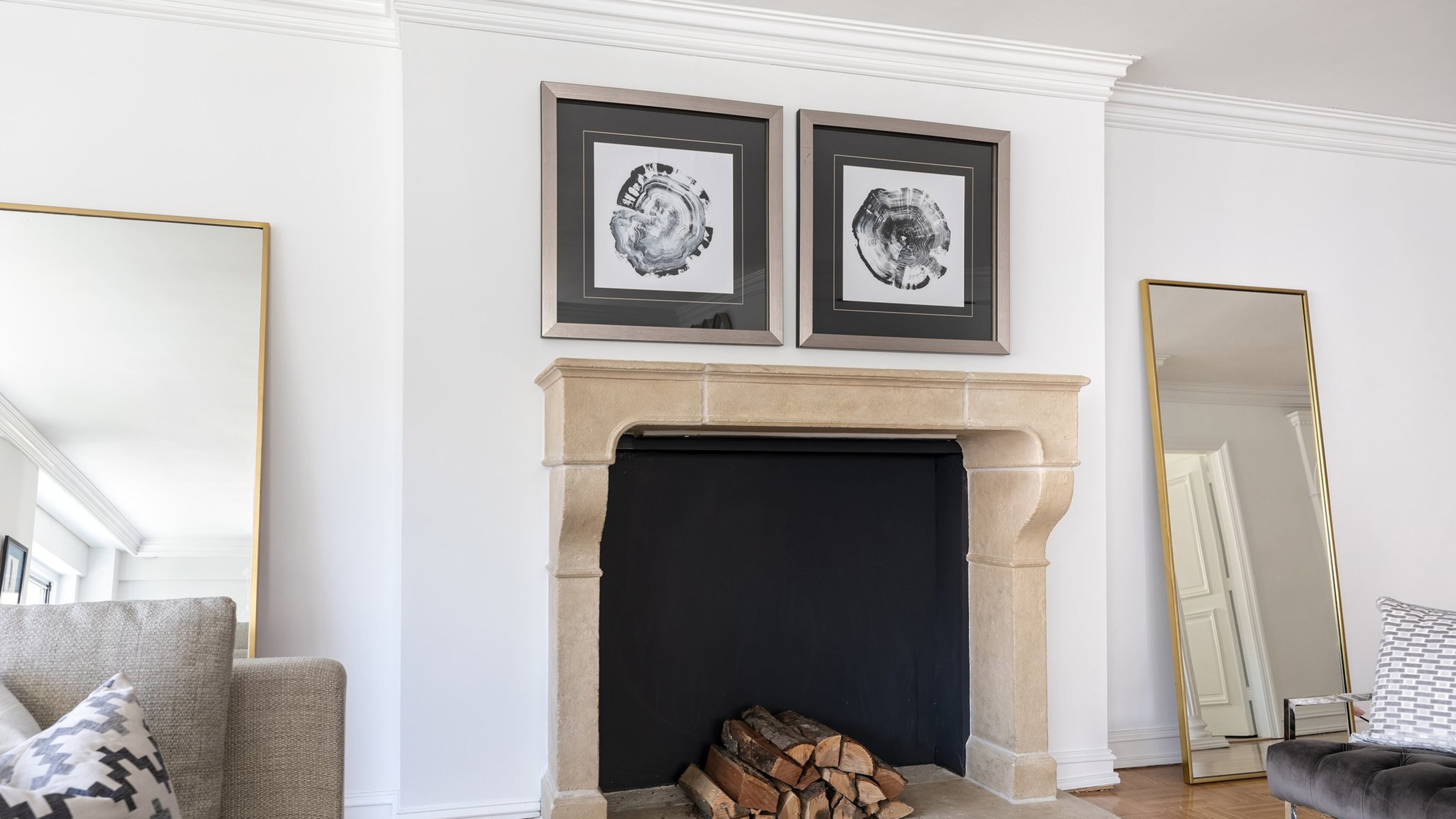 A pair of hung art pieces and leaning mirrors help fram a fireplace mantel. (Design Recipes)