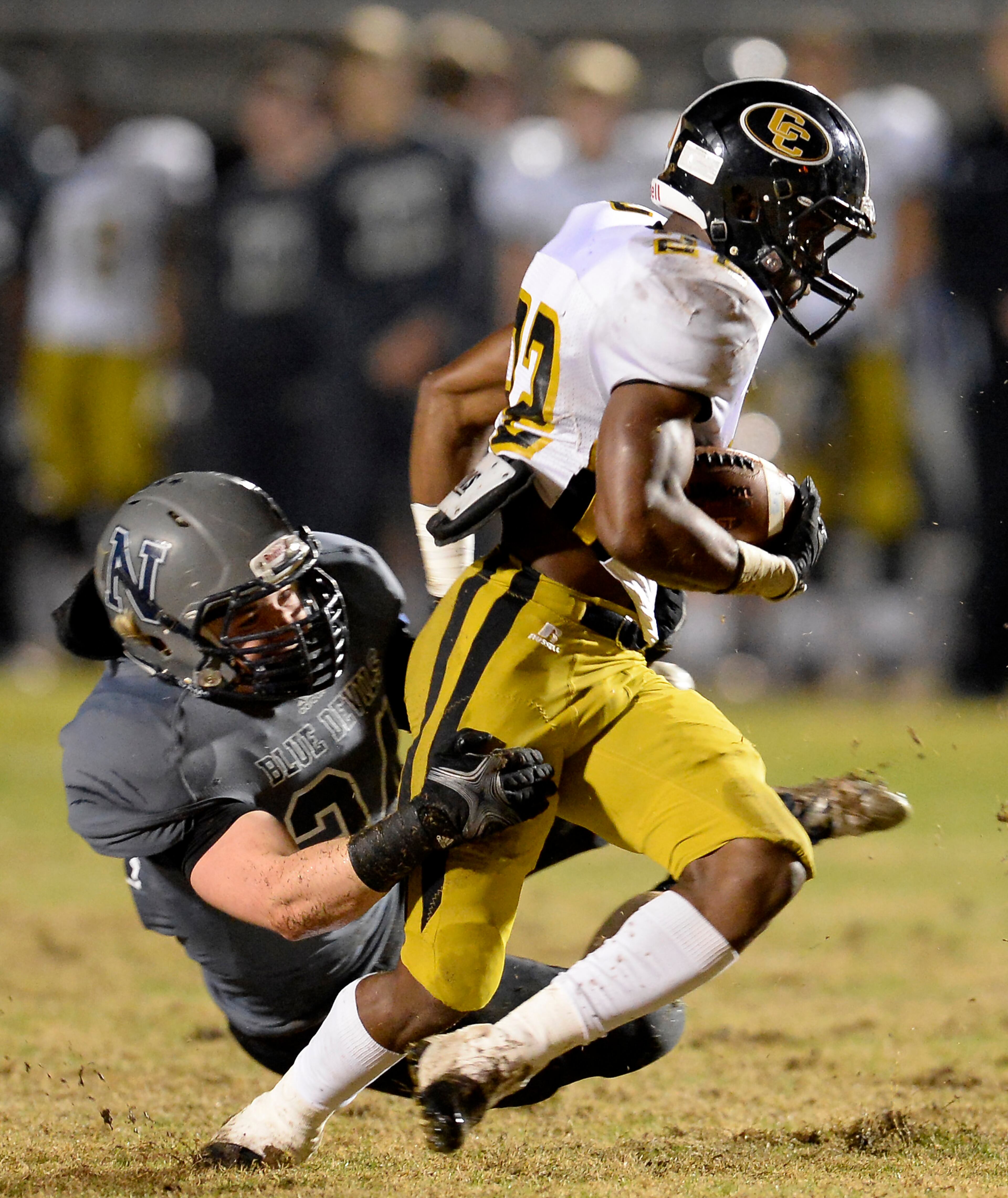 Colquitt County's Sihiem King (22) is brought down by Norcross defender Warren McWilliams in the first half of their AAAAAA semifinal game at Blue Devil Stadium on Friday, Dec. 6, 2013, in Norcross, Ga.