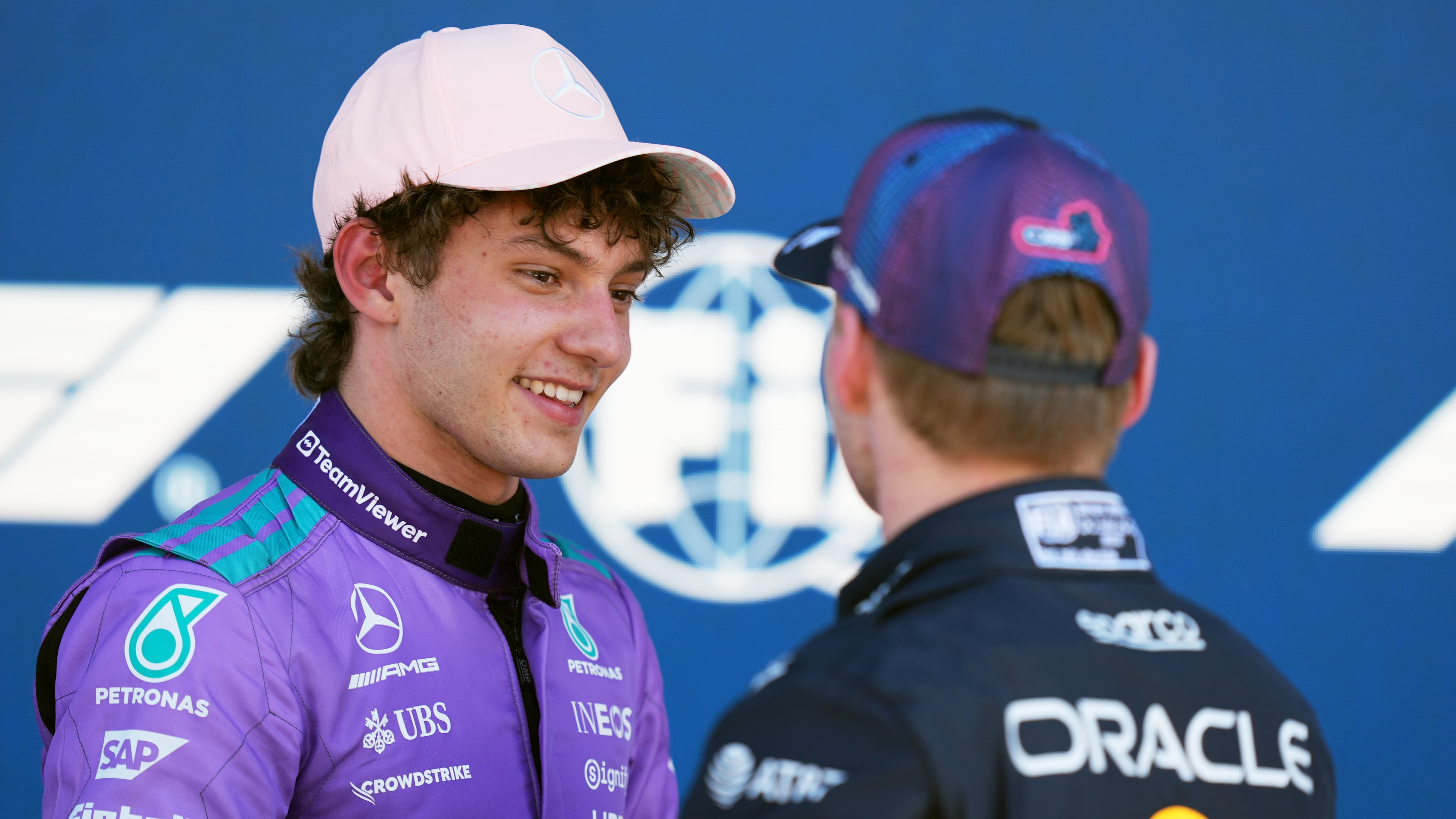 Mercedes driver Kimi Antonelli of Italy talks with Red Bull driver Max Verstappen of the Netherlands after a qualifying session for the Miami Formula One Grand Prix auto race, Saturday, May 2, 2026, in Miami Gardens, Fla. (AP Photo/Rebecca Blackwell)