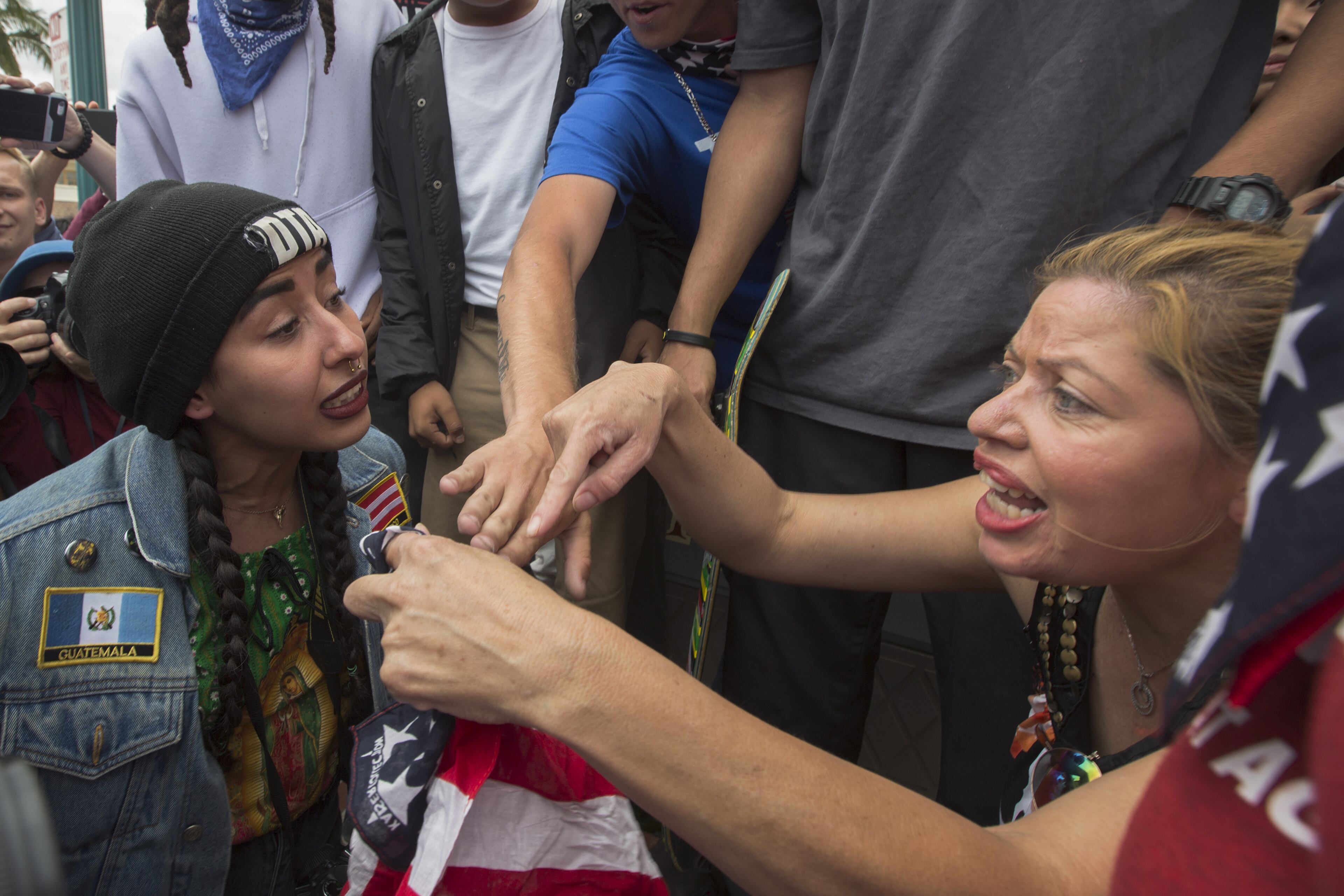 ANAHEIM, CA - MAY 25: An anti-Trump Latina protester (L) and a Latina Trump supporter clash near a campaign rally by presumptive GOP presidential candidate Donald Trump at the Anaheim Convention Center on May 25, 2016 in Anaheim, California. Previous visits by the candidate to Orange County have sparked in protests that resulted in some arrests. The presidential candidates are campaigning in Southern California for the June 7 California primary. (Photo by David McNew/Getty Images)
