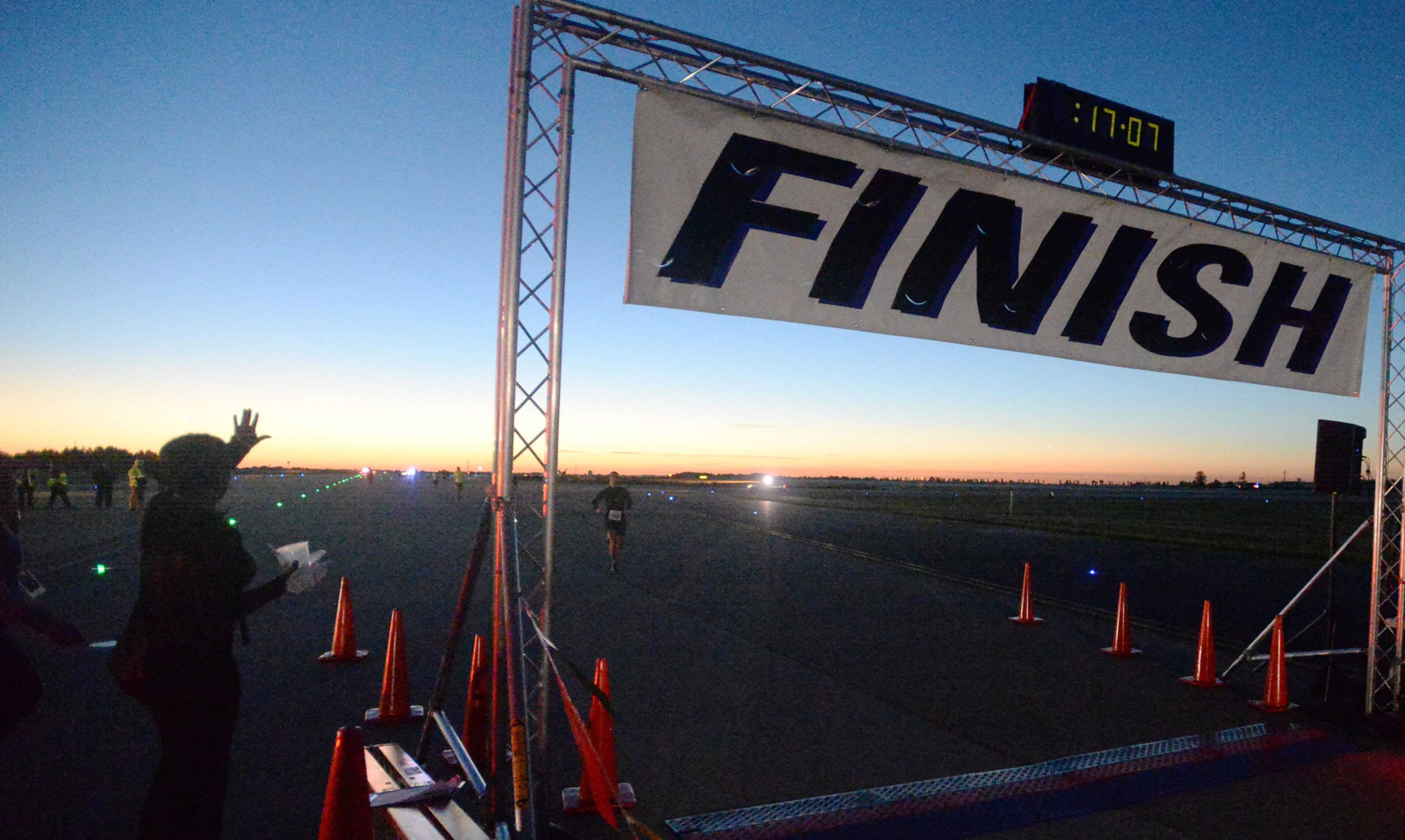 OCTOBER 17, 2015 ATLANTA Runners approach the finish line as the sun rises. Mayor Kasim Reed and United Way President Milton Little joined more than 2,000 runners at the Mayor’s Inaugural 5K on the 5th Runway at the world’s busiest airport Saturday, October 17, 2015. Airport officials shut down the 5th runway (Runway 10/28) until 8:15 am so runners and walkers could exit the course. All proceeds from the event will benefit United Way of Greater Atlanta. Major sponsors of The Mayor’s Inaugural 5K on the 5th Runway include Delta Air Lines, The Coca-Cola Company, Enterprise Rental Car, Georgia International Convention Center, MARTA, and Publix. Over $123,000 was raised, said airport spokesman Reese McCranie. The race's overall winner was Andrew Murfee, 15, a Woodward Academy student. KENT D. JOHNSON/KDJOHNSON@AJC.COM