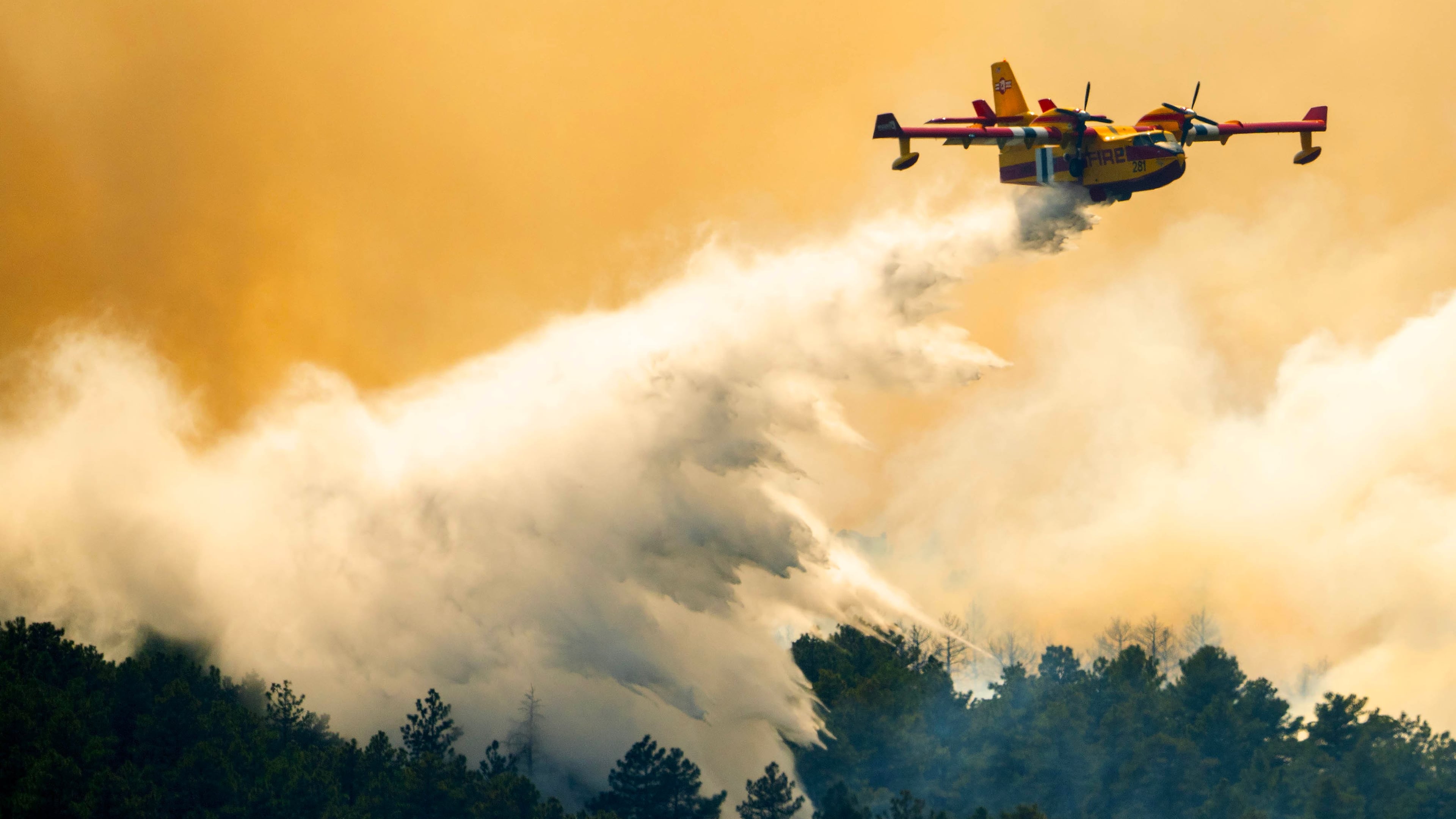 A plane drops a load of water on the Aspen Acres Fire near Colorado City, Colo., on Thursday, July 2, 2026. (Michael Seamans/The Gazette via AP)