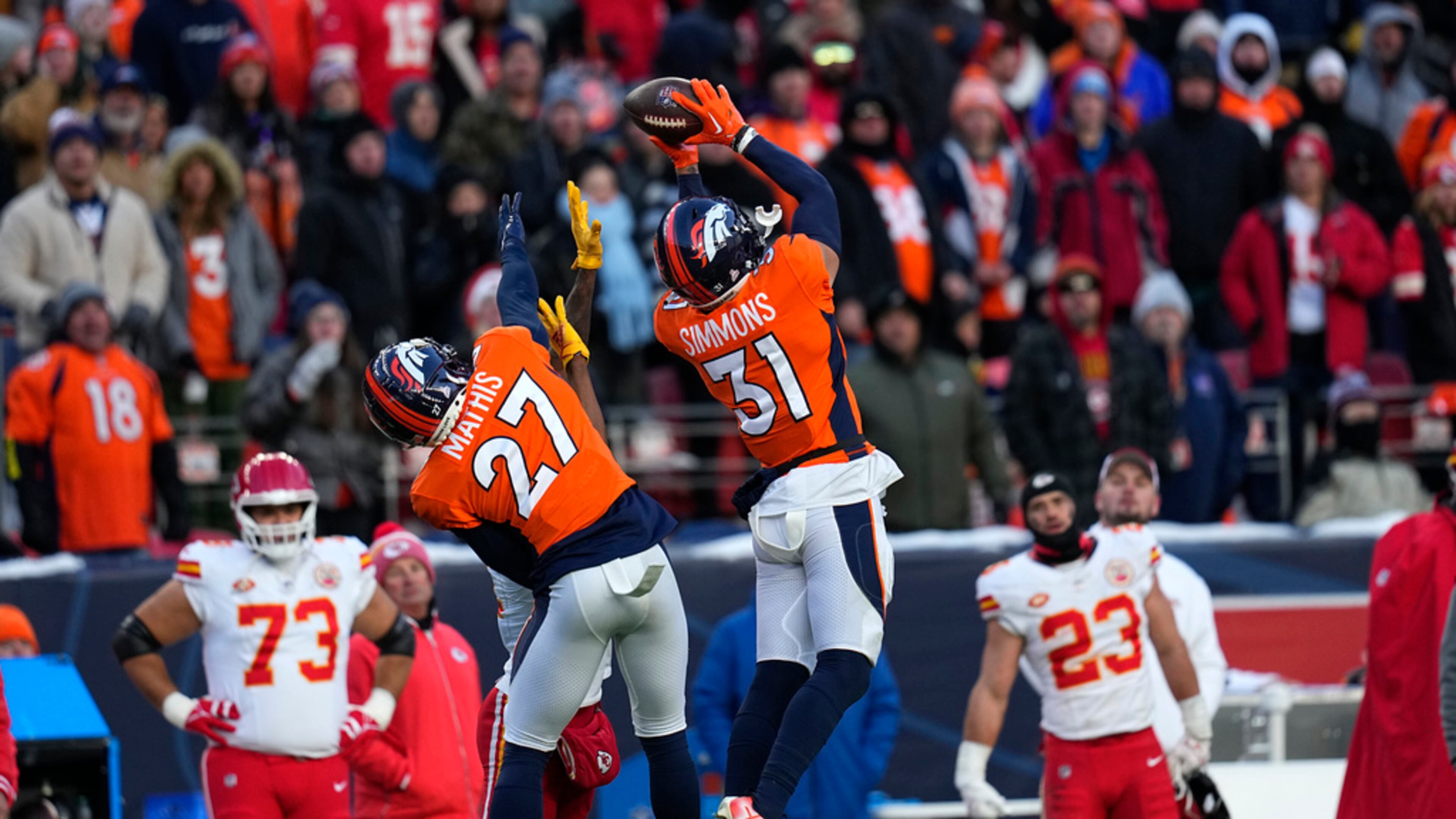 FILE - Denver Broncos safety Justin Simmons (31) intercepts a pass as teammate Damarri Mathis (27) watches during the second half of an NFL football game against the Kansas City Chiefs Sunday, Oct. 29, 2023, in Denver. Simmons was voted one of the top five safeties at the midpoint of the season by The Associated Press. (AP Photo/Jack Dempsey, File)