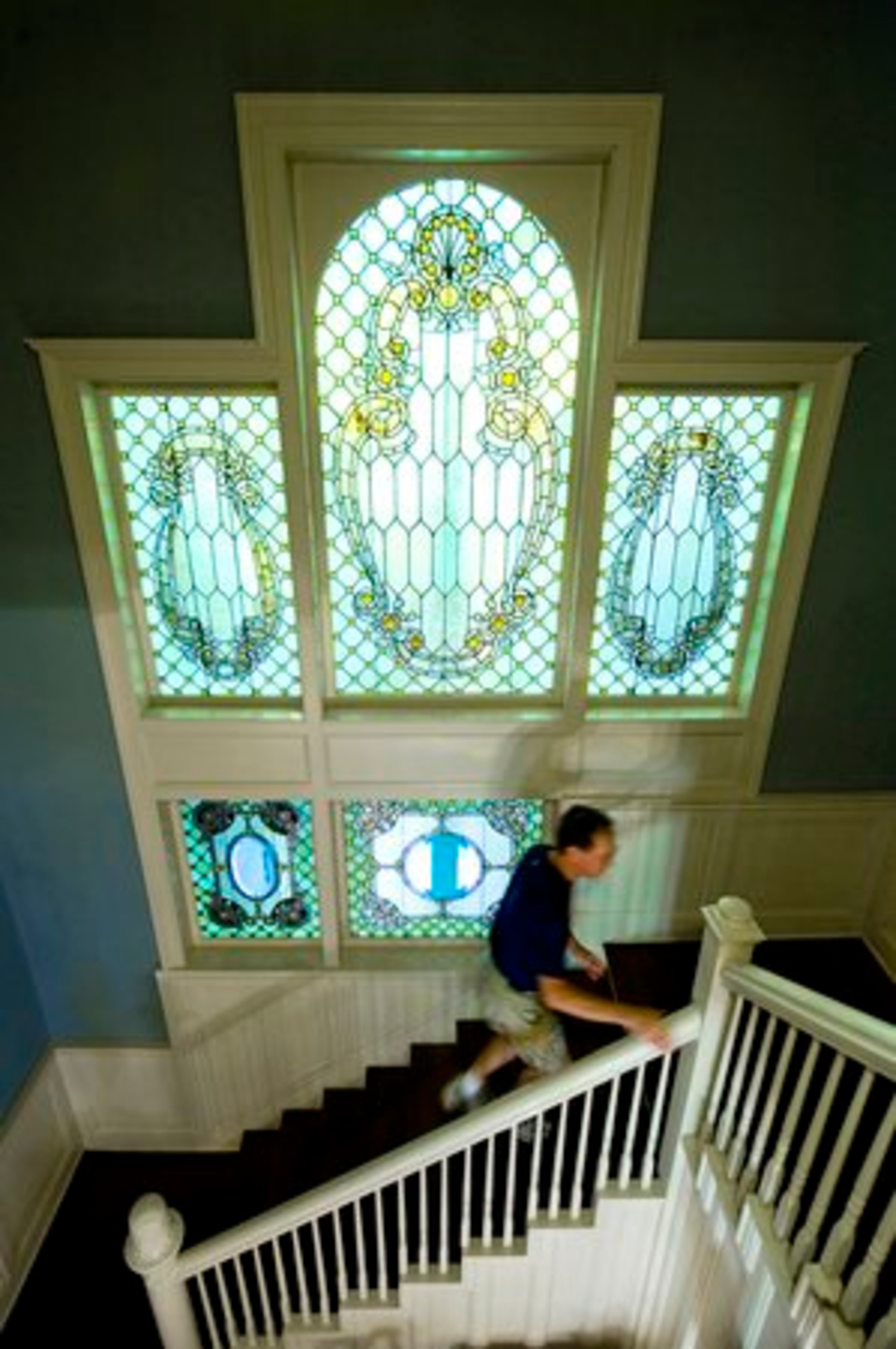 An original feature of the home is a two-story, five-panel stained glass window.