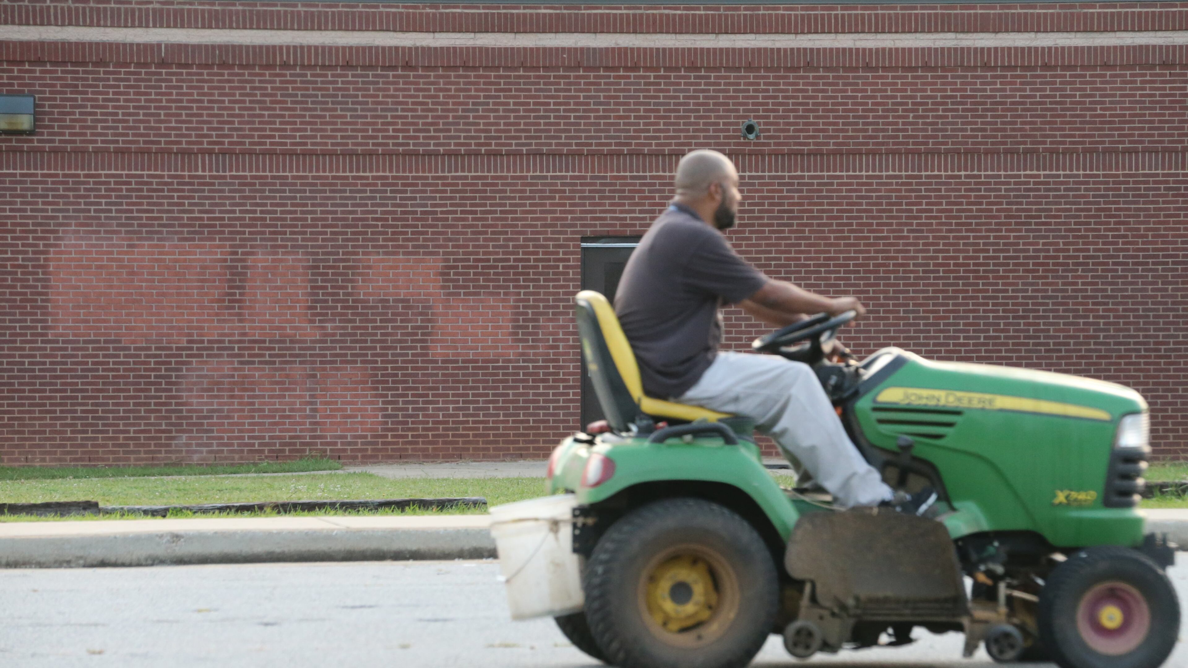 A maintenance staff worker examines Stephenson High School in DeKalb County after vandals reportedly spray-painted graffiti on the campus. JOHN SPINK / JSPINK@AJC.COM