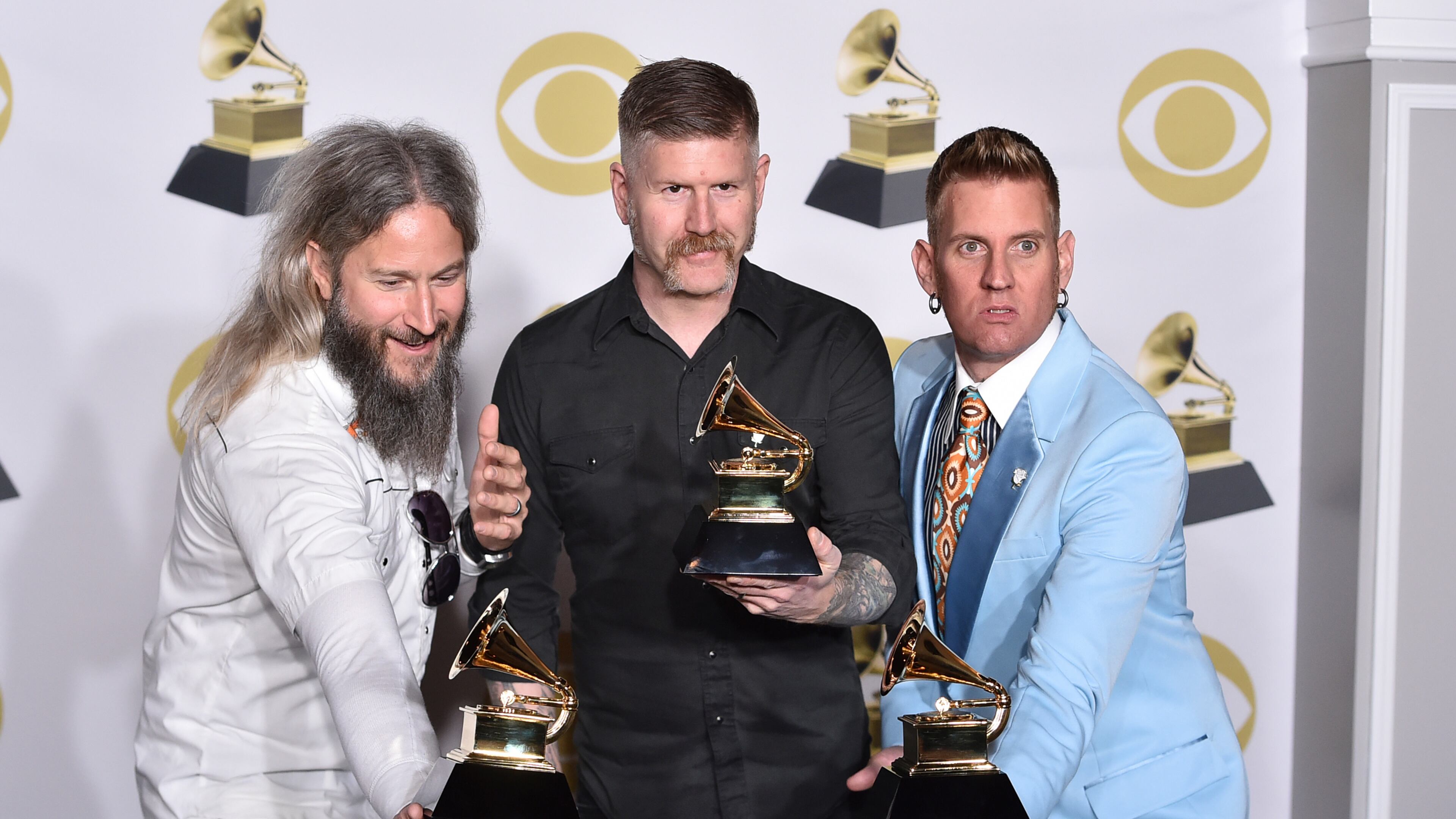 Troy Sanders, from left, Bill Kelliher and Brann Dailor of Mastodon pose in the press room with the best metal performance award for "Sultan's Curse" at the 60th annual Grammy Awards at Madison Square Garden on Sunday, Jan. 28, 2018, in New York. (Photo by Charles Sykes/Invision/AP)