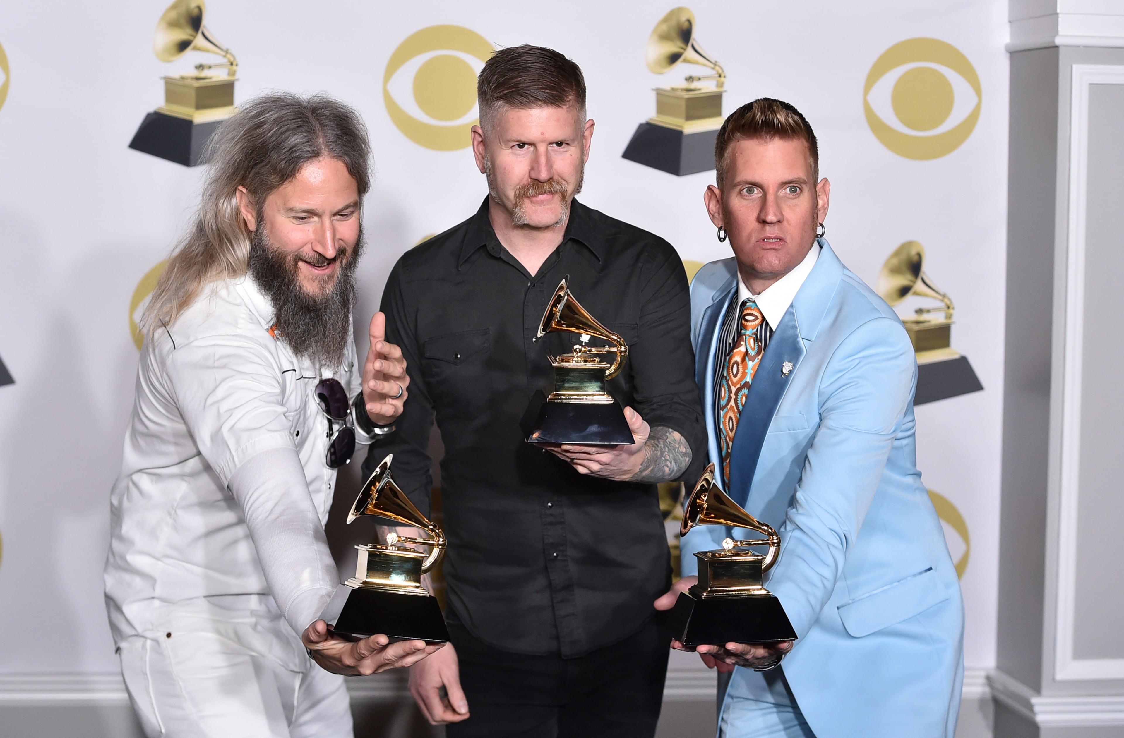 Troy Sanders, from left, Bill Kelliher and Brann Dailor of Mastodon pose in the press room with the best metal performance award for "Sultan's Curse" at the 60th annual Grammy Awards at Madison Square Garden on Sunday, Jan. 28, 2018, in New York. (Photo by Charles Sykes/Invision/AP)