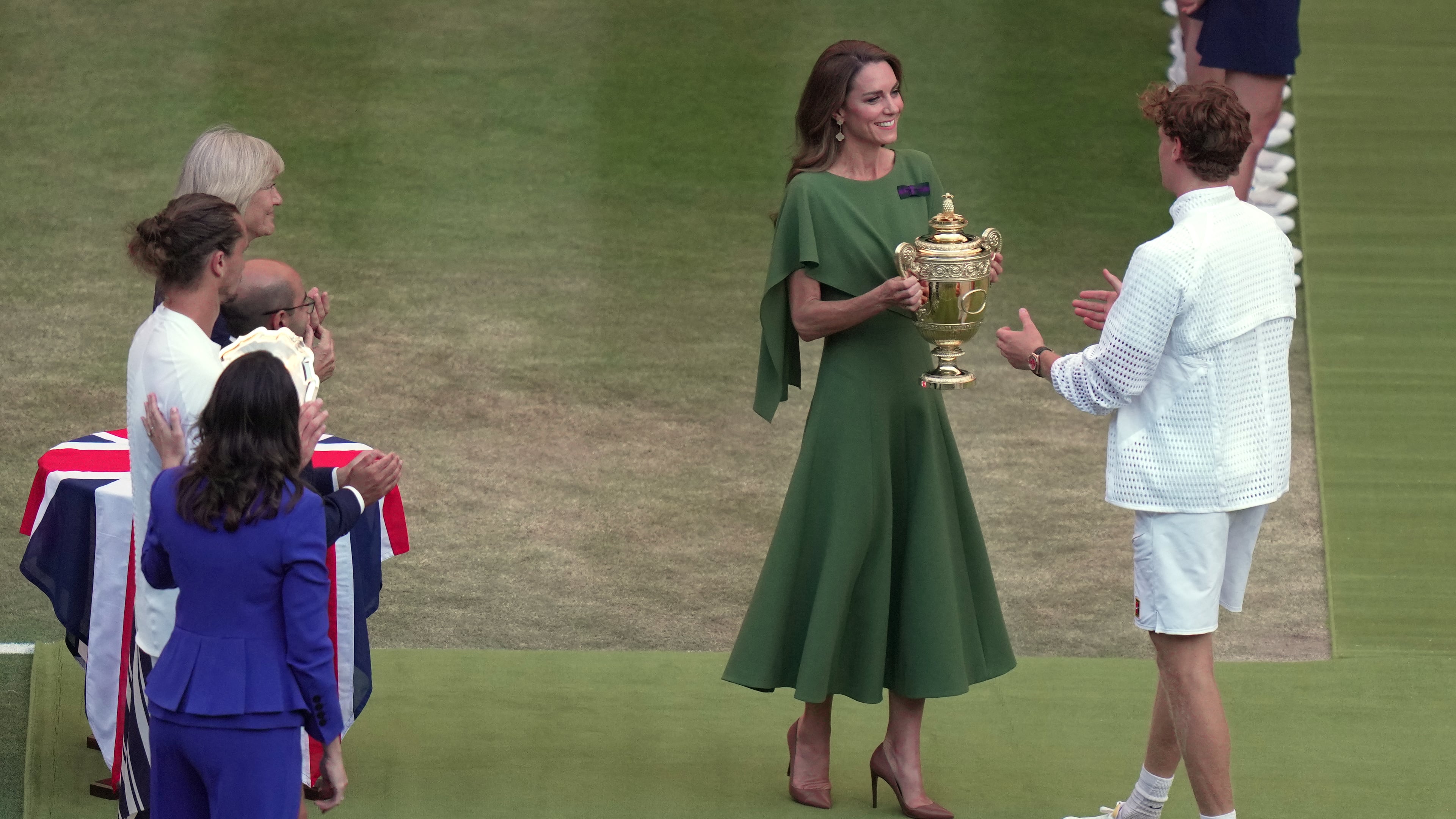 Britain's Princess Kate presents the champion trophy to Jannik Sinner of Italy after winning against Alexander Zverev of Germany in the men's singles final at Wimbledon Tennis Championships in London, Sunday, July 12, 2026. (AP Photo/Brian Inganga)