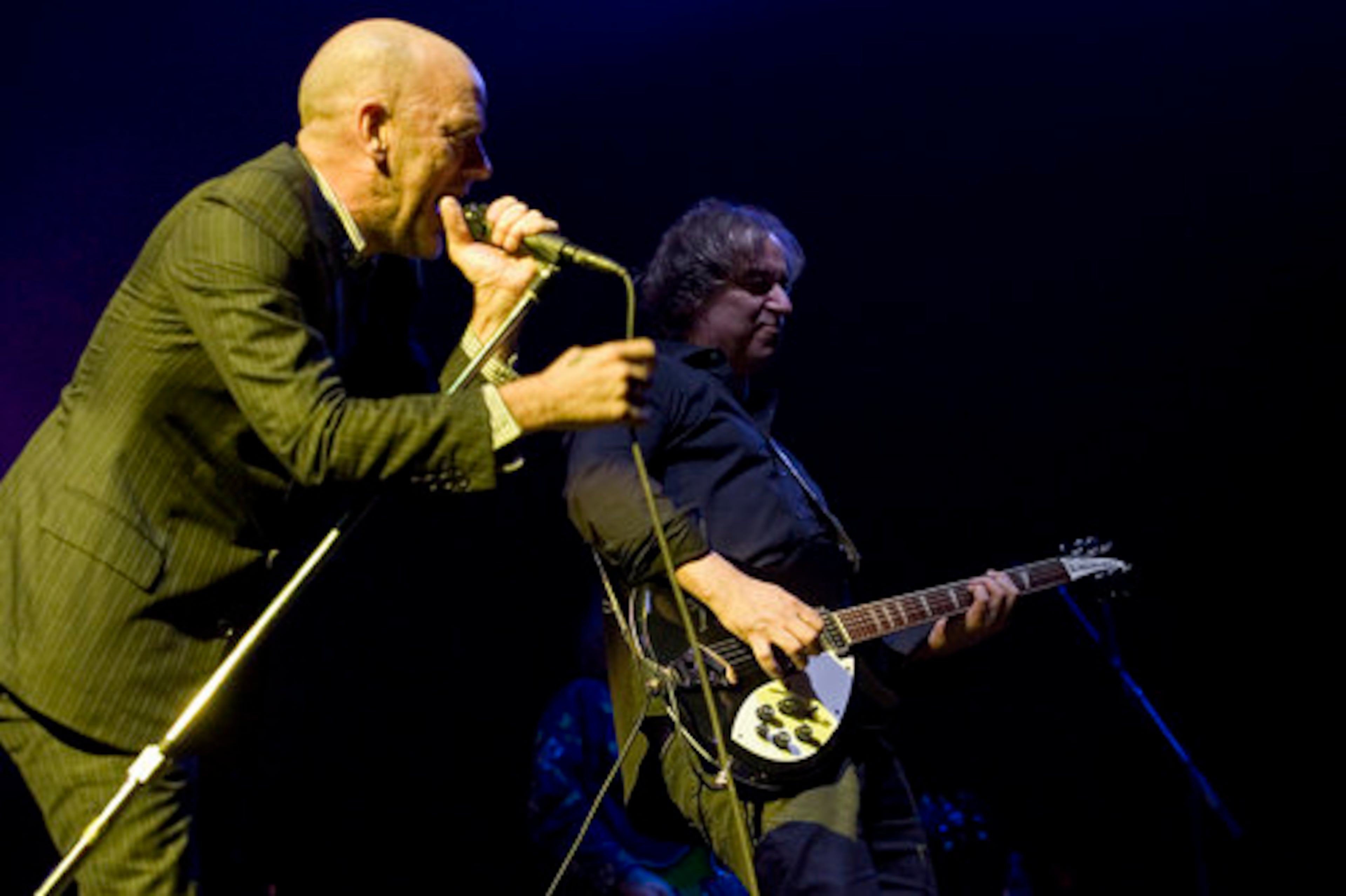 R.E.M. vocalist Michael Stipe and guitarist Peter Buck perform.