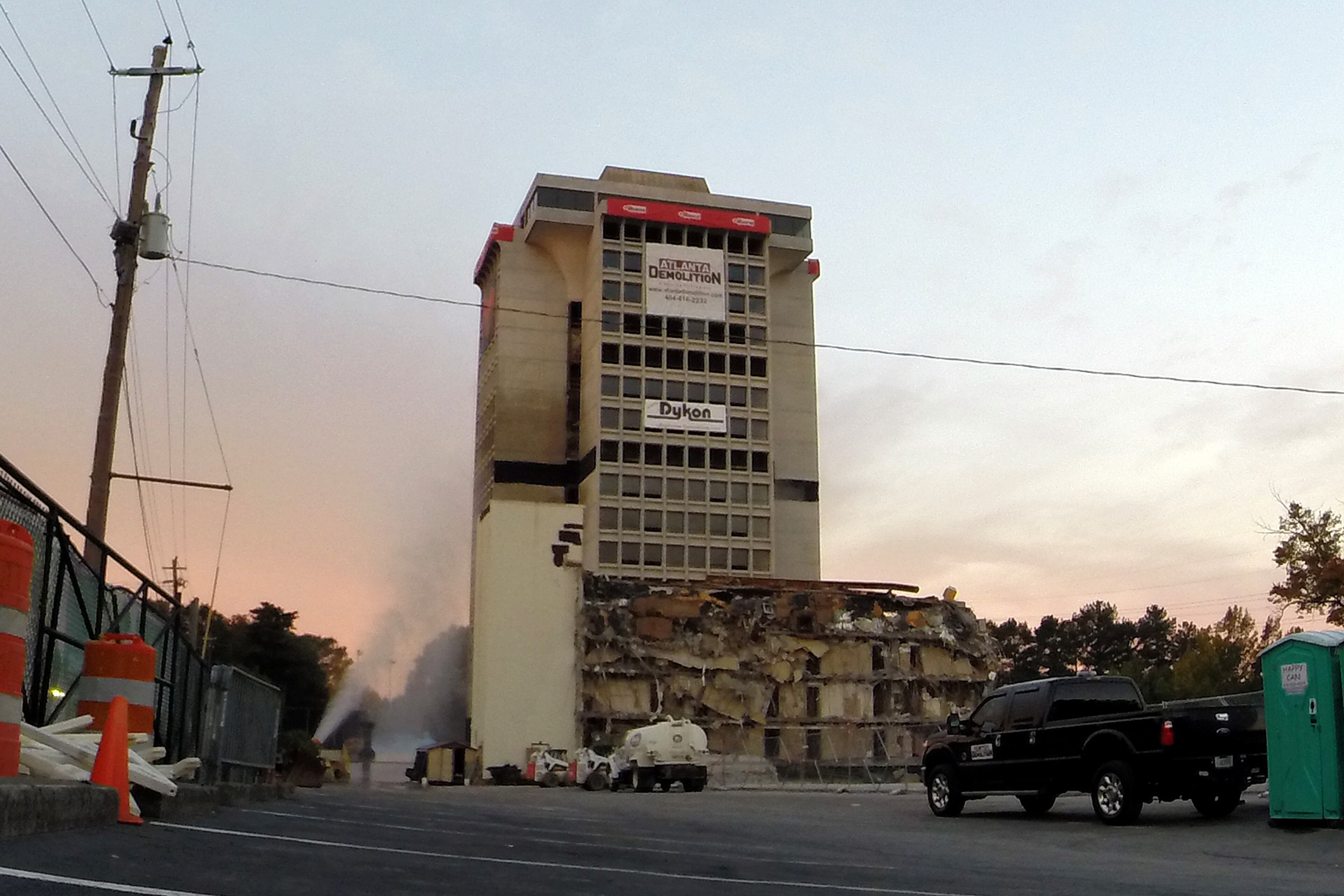 The 19-story former Executive Park Motor building is imploded at the corner of I-85 and North Druid Hills Road on Saturday morning, November 8, 2014. HYOSUB SHIN / HSHIN@AJC.COM