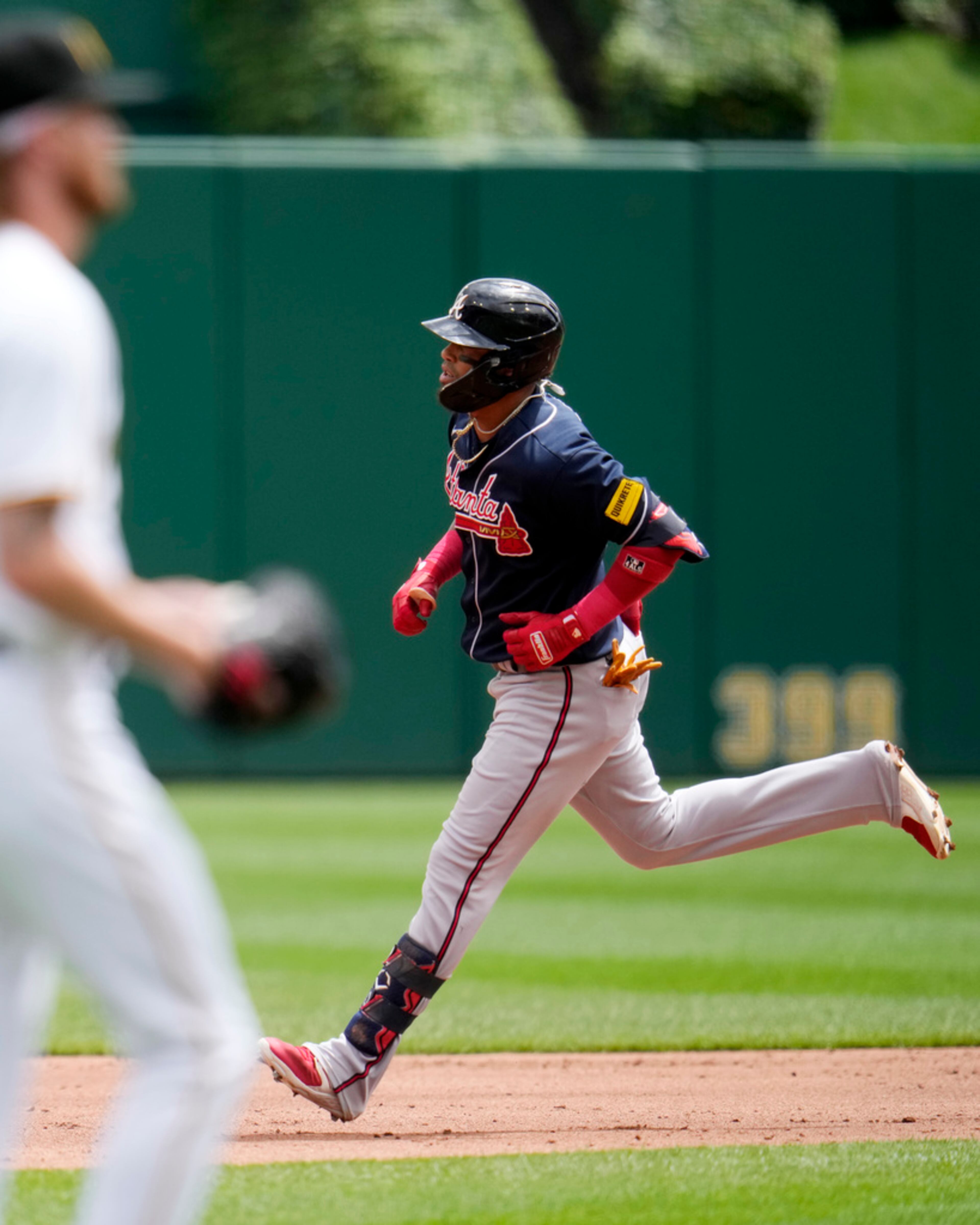 Atlanta Braves' Orlando Arcia, right, rounds the bases after hitting a solo home run off Pittsburgh Pirates starting pitcher Bailey Falter, left, during the second inning of a baseball game in Pittsburgh, Thursday, Aug. 10, 2023. (AP Photo/Gene J. Puskar)