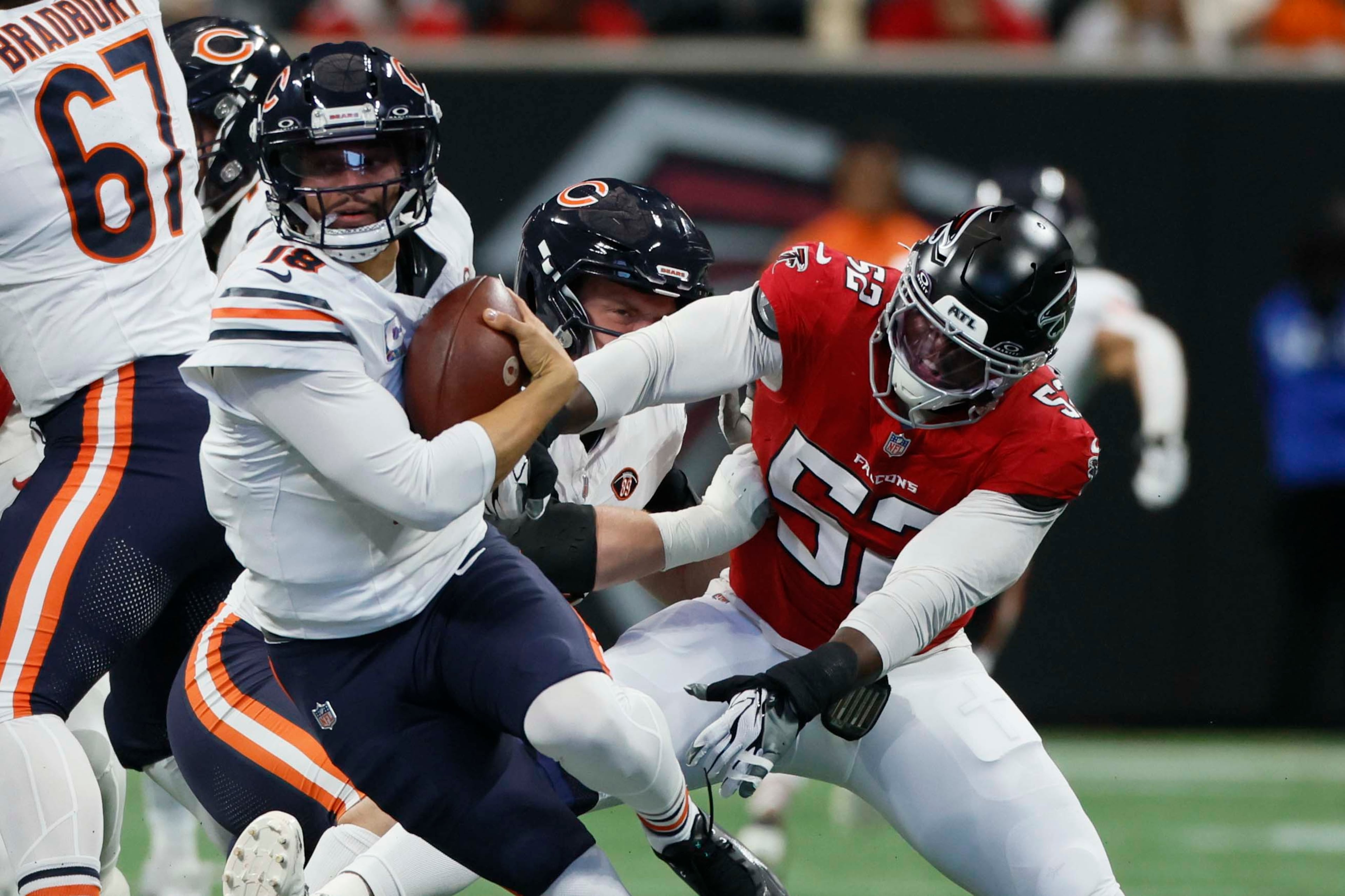 Atlanta Falcons defensive end Samson Ebukam (right) pursues Chicago Bears quarterback Caleb Williams in the first half of an NFL game at Mercedes-Benz Stadium in Atlanta on Sunday, Oct. 18, 2026. (Miguel Martinez/AJC)