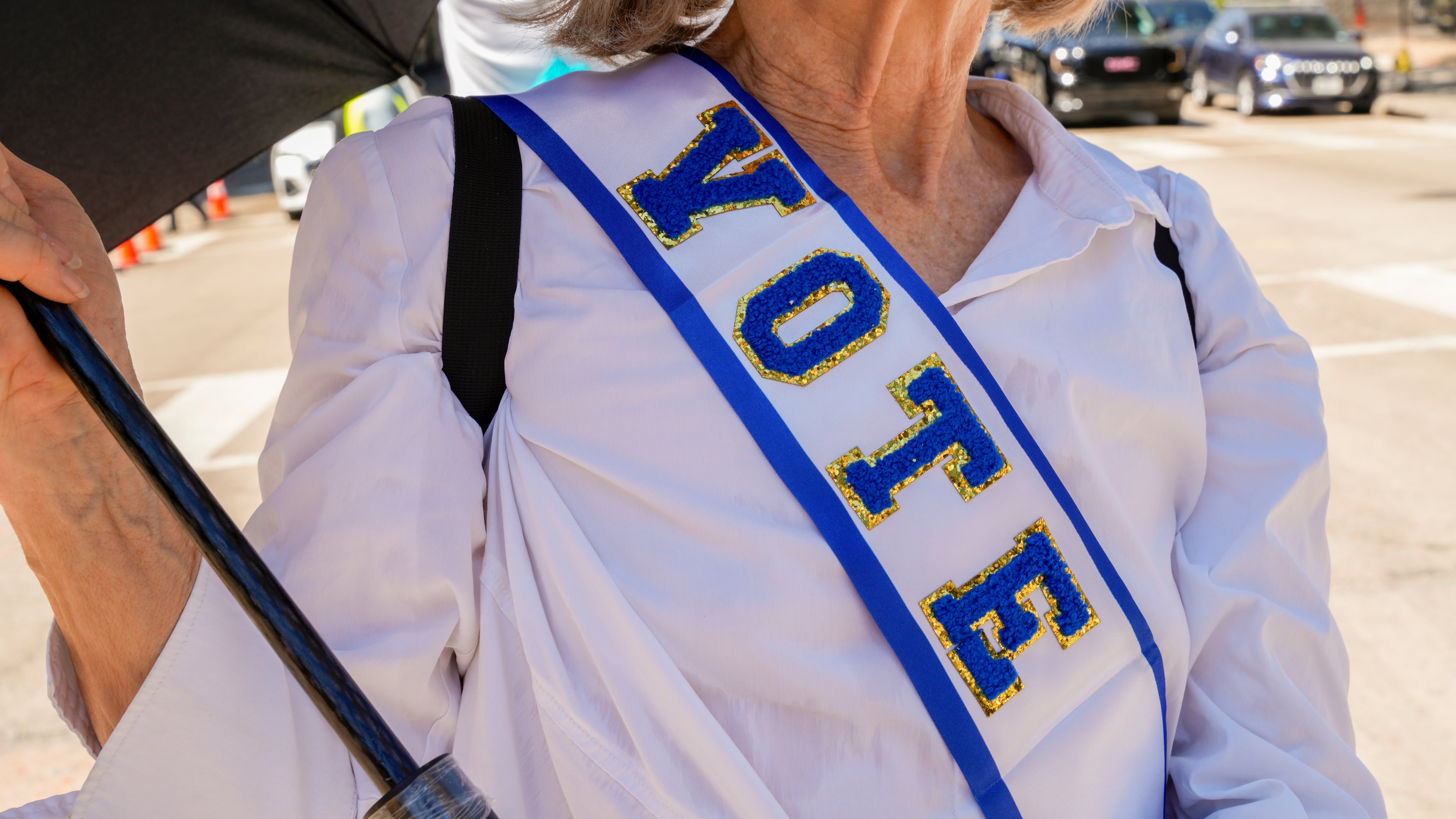 Protestor, Linda James, poses for photo with her "VOTE" sash at the Dallas March on the RNC Midterm Convention in Dallas, Thursday, Sept. 10, 2026. (AP Photo/Gabriela Passos)