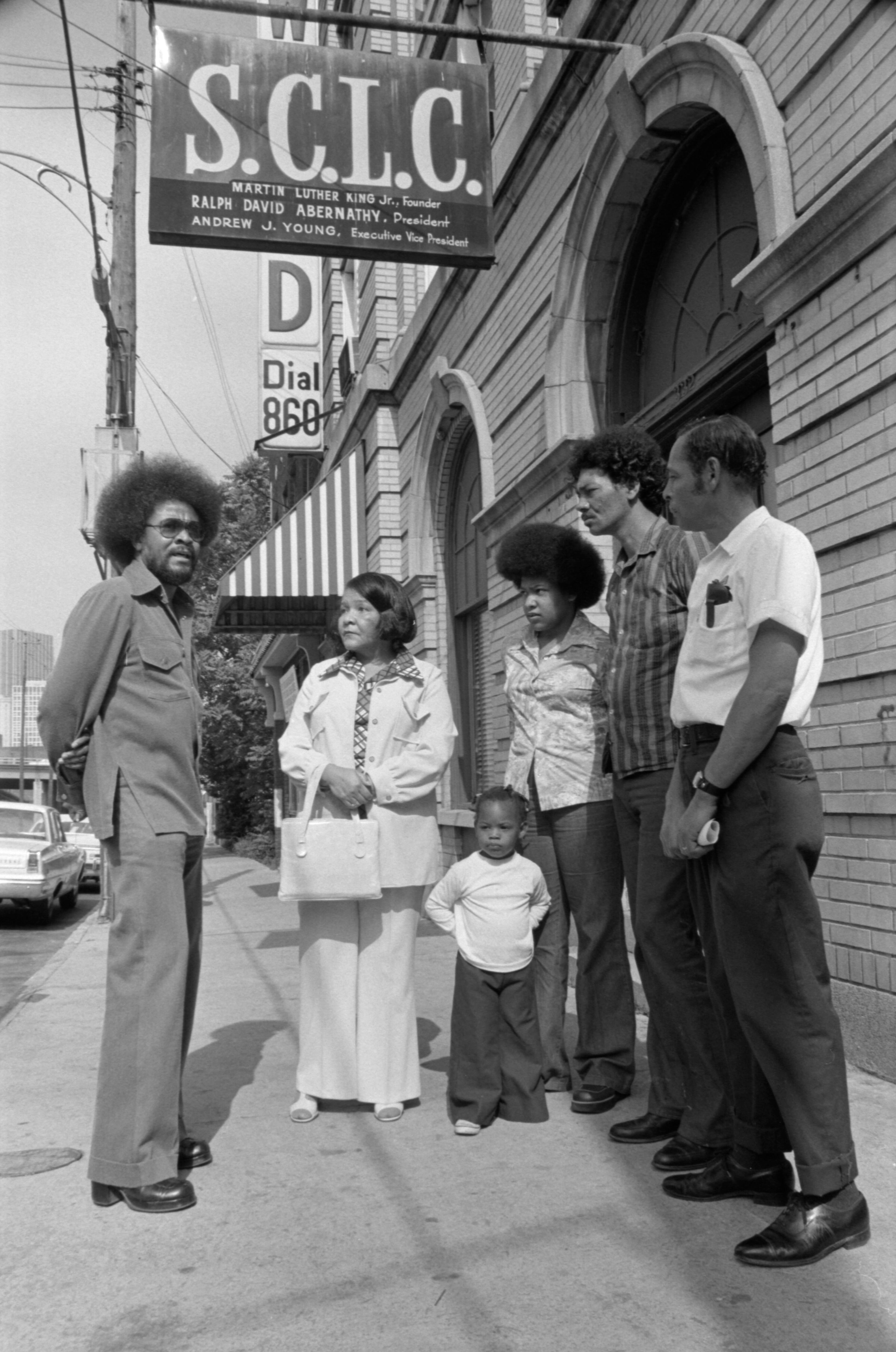 Tyrone Brooks (far left), then a Southern Christian Leadership Conference staffer, talks with an unidentified family outside the SCLC office on Auburn Avenue in this undated photo. The SCLC has roots dating back to the late '50s, when a group of civil rights leaders founded the organization to promote nonviolent action against segregation. The Rev. Martin Luther King Jr. was its first president. Photo: Boyd Lewis, courtesy of Kenan Research Center at the Atlanta History Center.