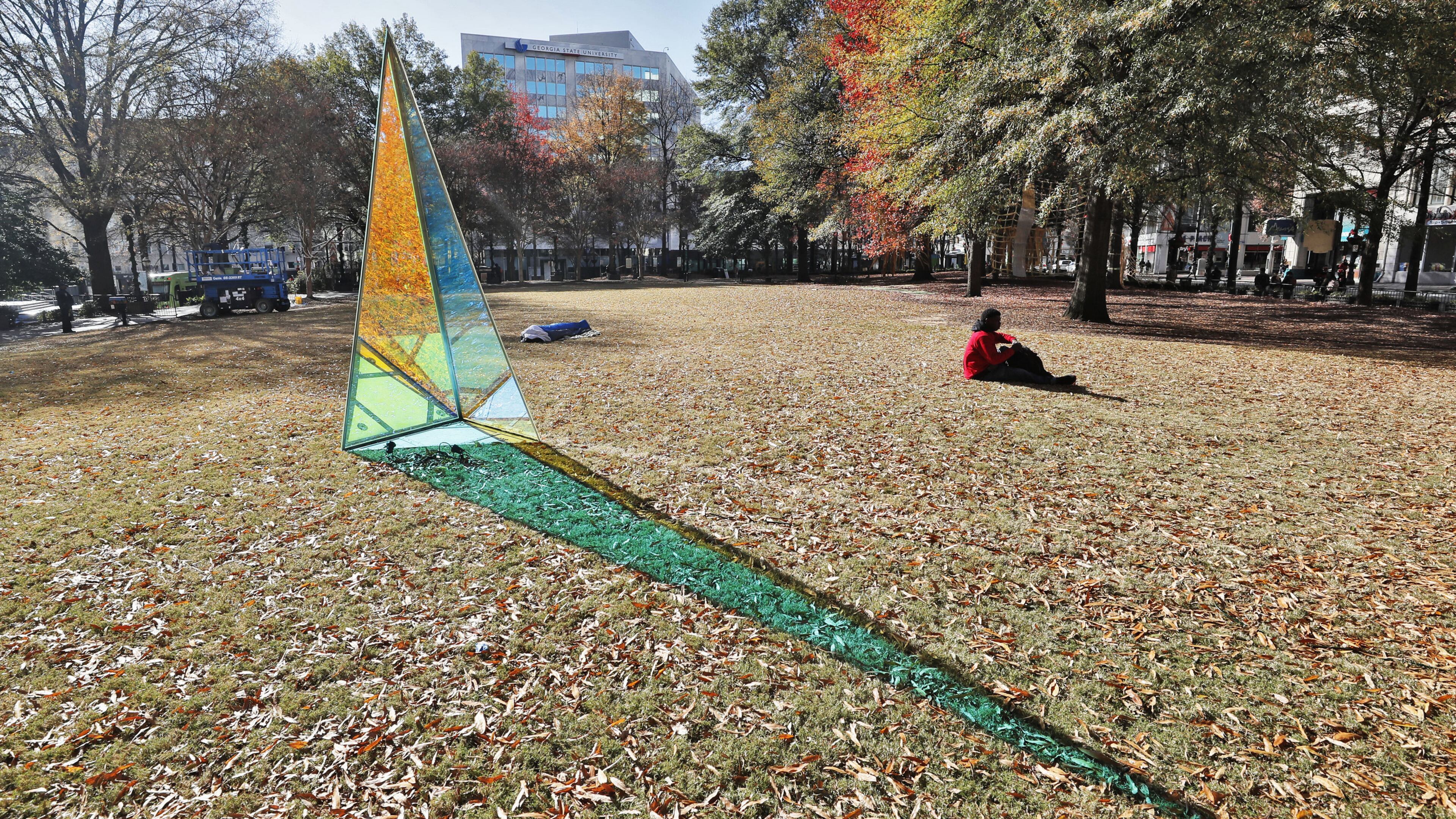 This light-shifting sculpture by David Baerwalde and Alex Martinez is part of the public art installation “PRISM: Winter Lights at Woodruff Park.” The exhibit spreads throughout the downtown park, enhancing existing landmarks like the International Peace Fountain and the iconic gazebo with geometric sculptures, "upcycled" lights, and a light garden. Bob Andres / bandres@ajc.com