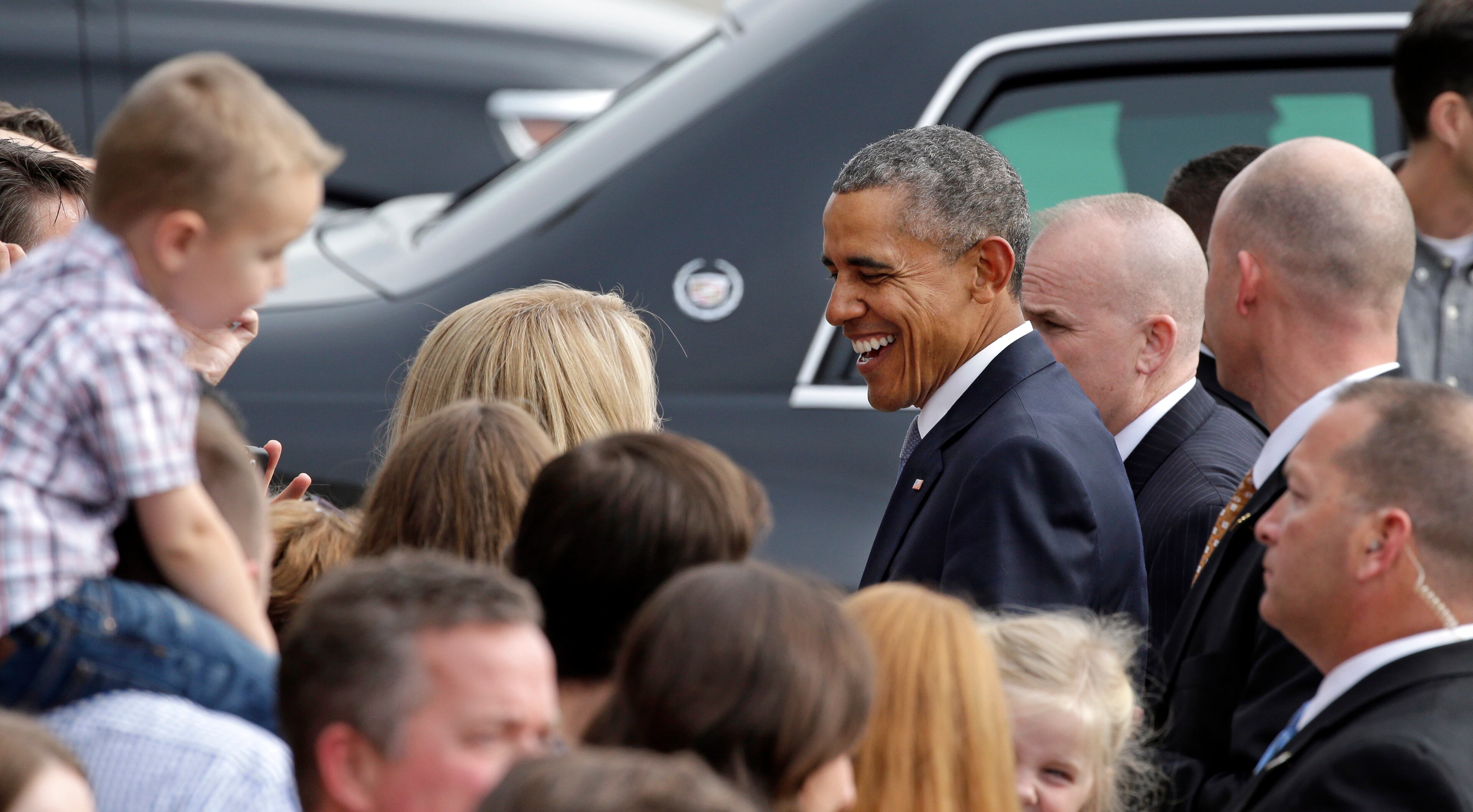 President Barack Obama greets a small group of people on his arrival Friday, Oct. 9, 2015, at King County Airport in Seattle. Obama was in town to attend a pair of fundraisers, following a stop Roseburg, Ore., where he visited families of victims of the shooting rampage there last week. (AP Photo/Elaine Thompson)