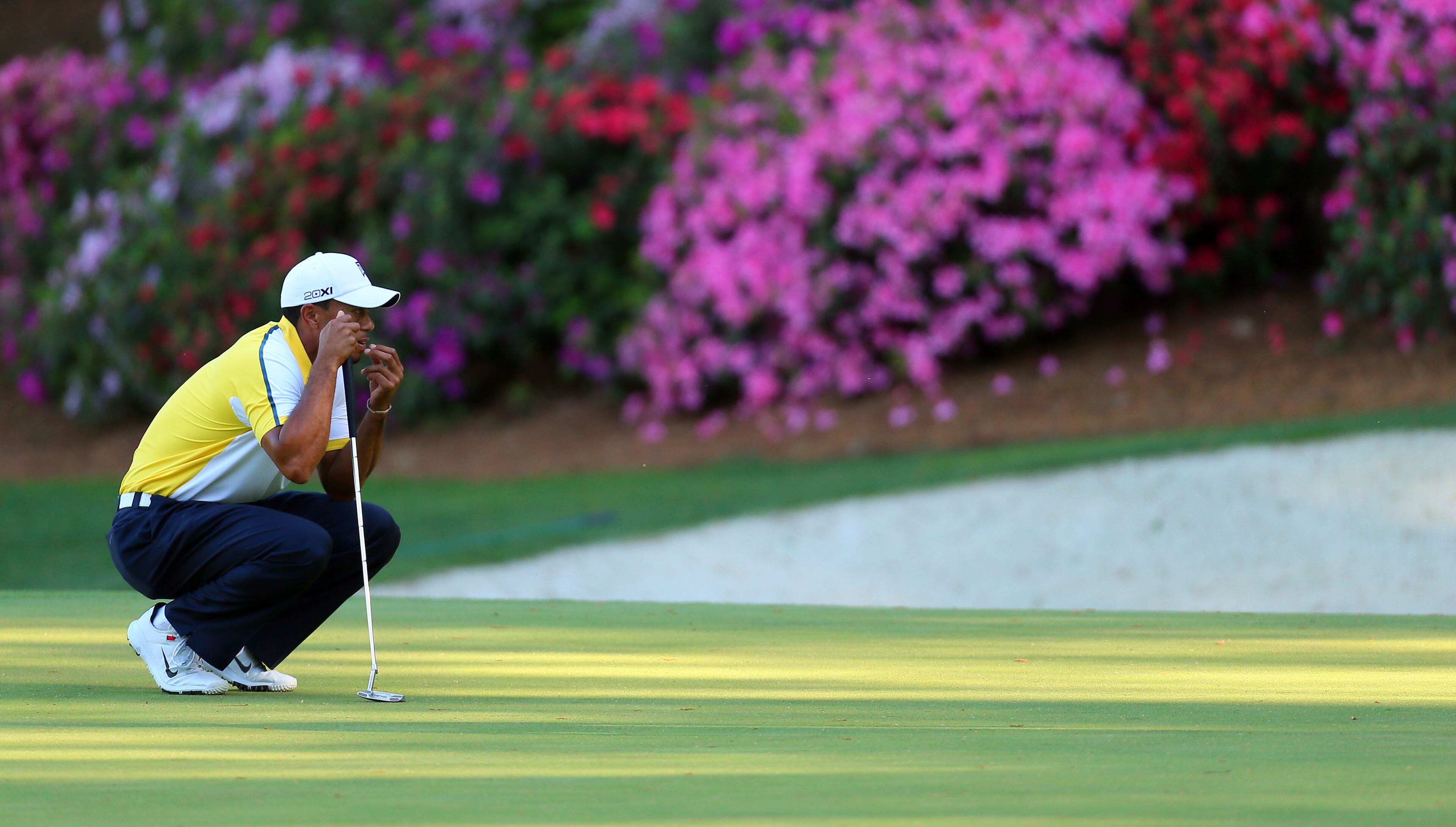 Tiger Woods looks over his birdie putt on #13 during the second round in the Masters Tournament on Friday April 12 2013. CURTIS COMPTON / CCOMPTON@AJC.COM