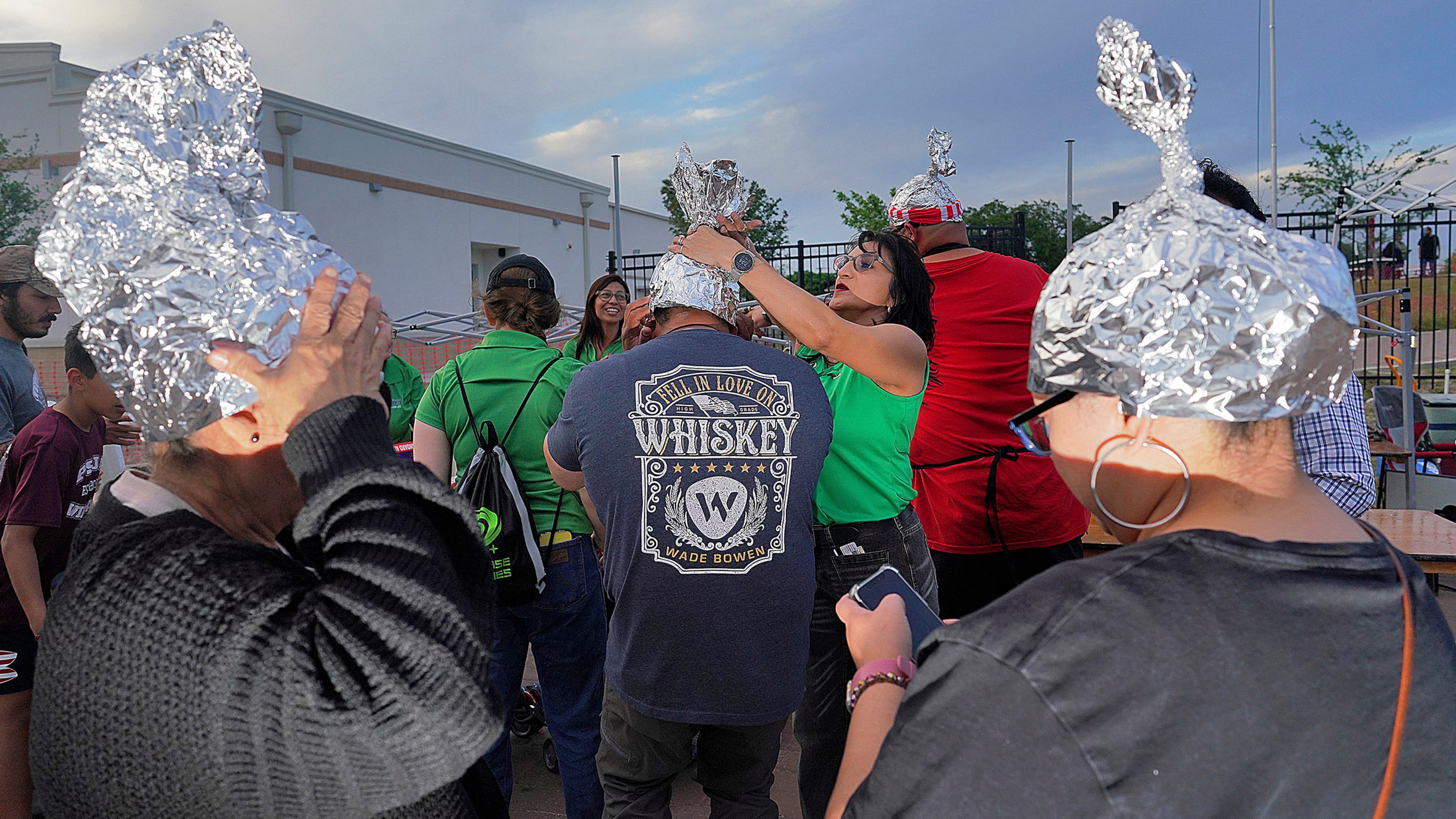 FILE - Attendees playfully wear tin foil hats at the Edinburg UFO Festival, April 5, 2024, in Edinburg, Texas. (Joel Martinez/The Monitor via AP, File)
