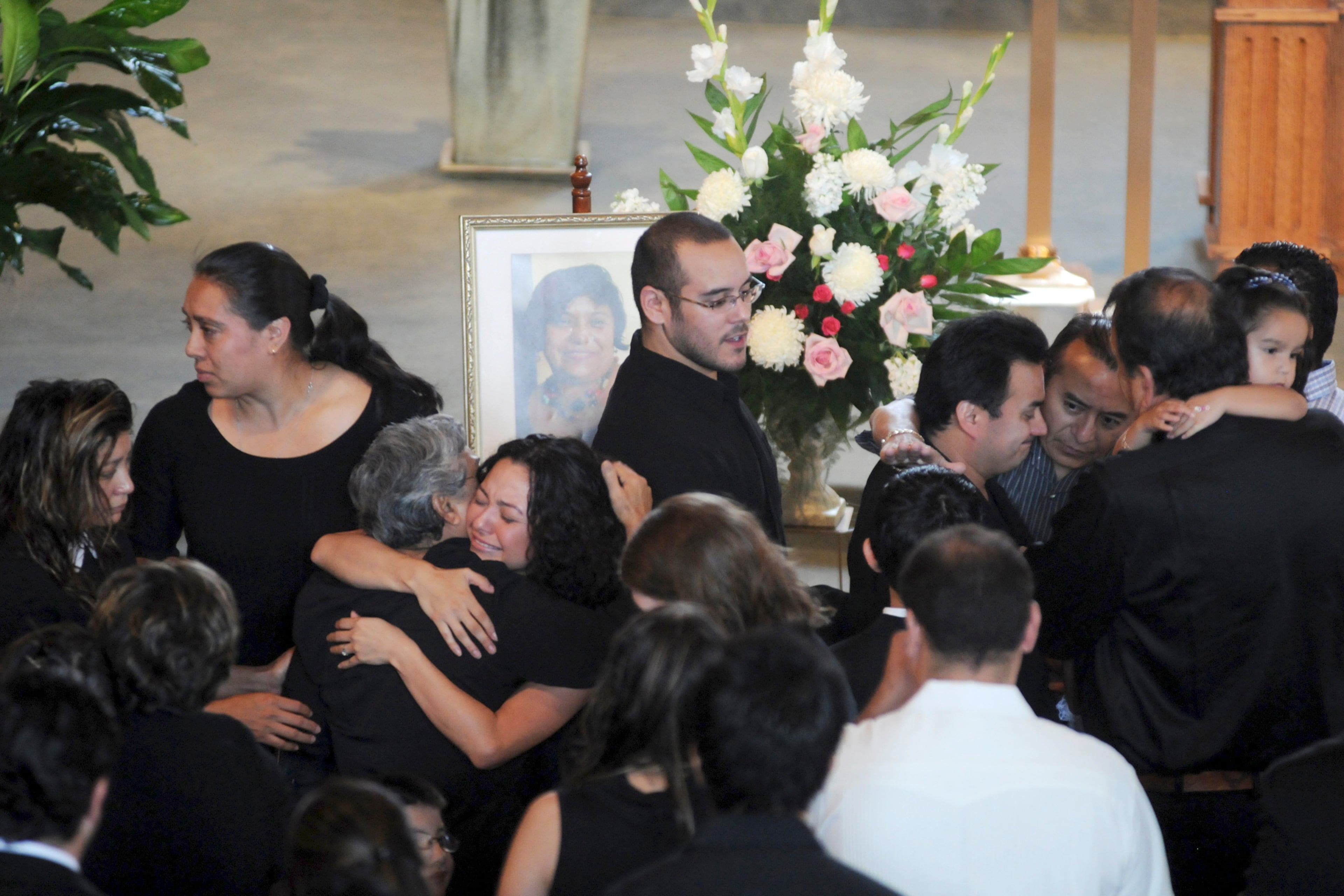 Family and friends of Seydi Burciaga find solace during the service ceremony at the Lady of the Americas in Lilburn. Saydi was one of the victims from the deadly September 2009 flood in Georgia. (AJC file photo/Miguel Martinez, Mundo Hispanico)