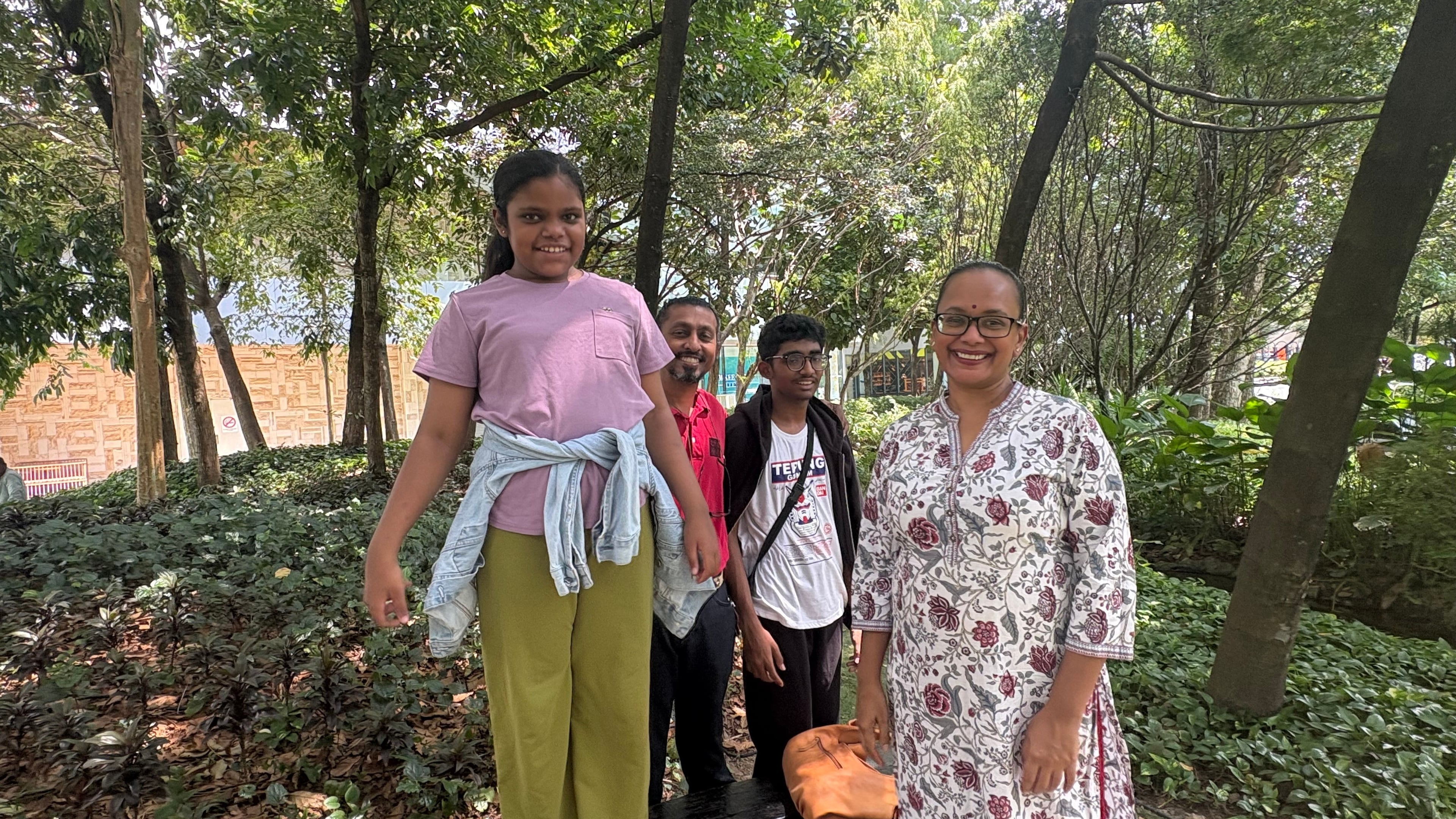 Jayaradha Veerasamy, right, and Saravanan Ganasan, second left, stand with their 12 years-old daughter Saaradha Saravanan, left, and their 15 year-old son Aadhavan Saravanan at a park in Petaling Jaya, near Kuala Lumpur, Malaysia Monday, June 1, 2026. (AP Photo/Eileen Ng)