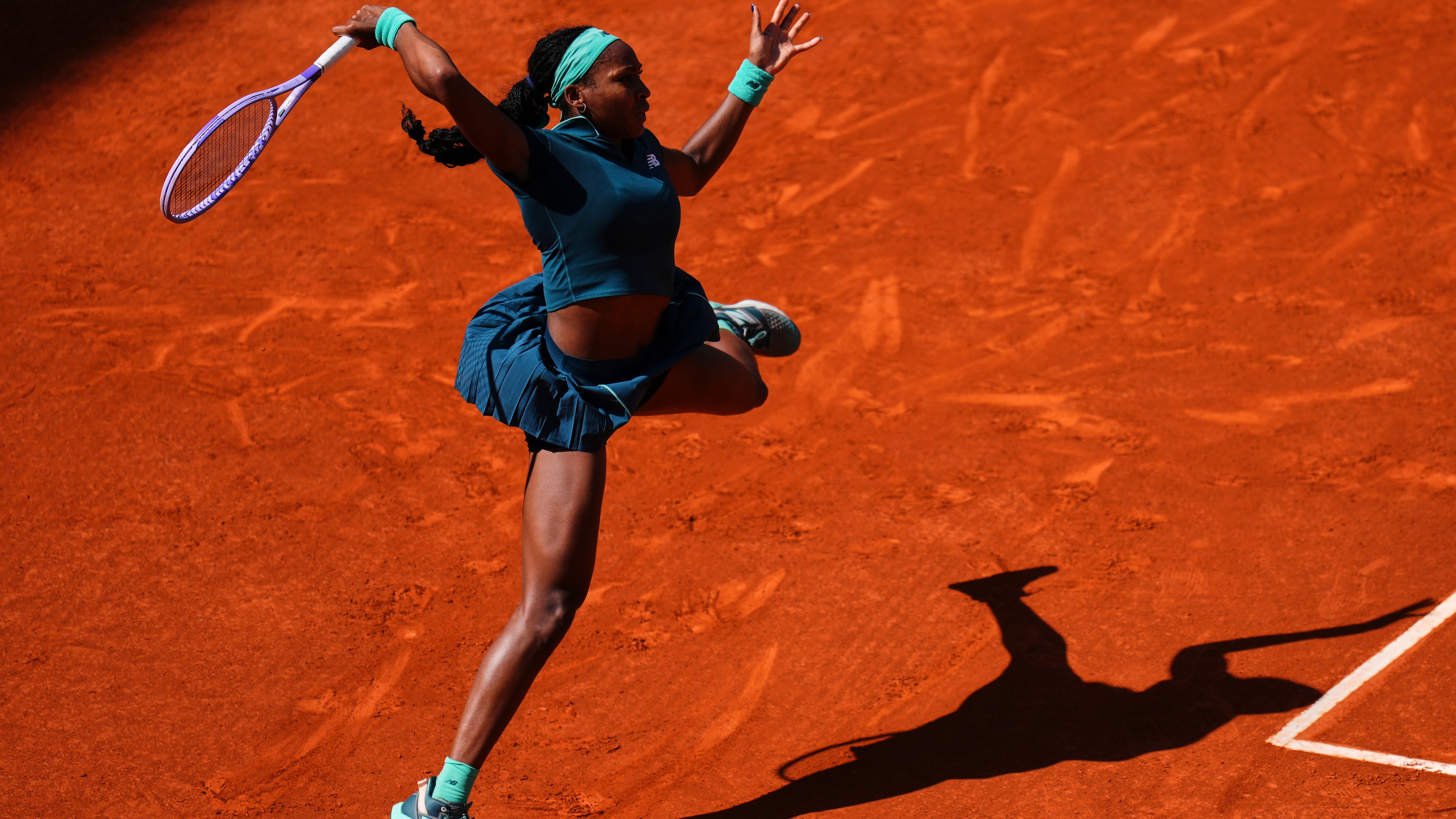 Coco Gauff of the U.S. returns the ball to Sorana Cirstea of Romania during the Madrid Open tennis tournament in Madrid, Sunday, April 26, 2026. (AP Photo/Manu Fernandez)