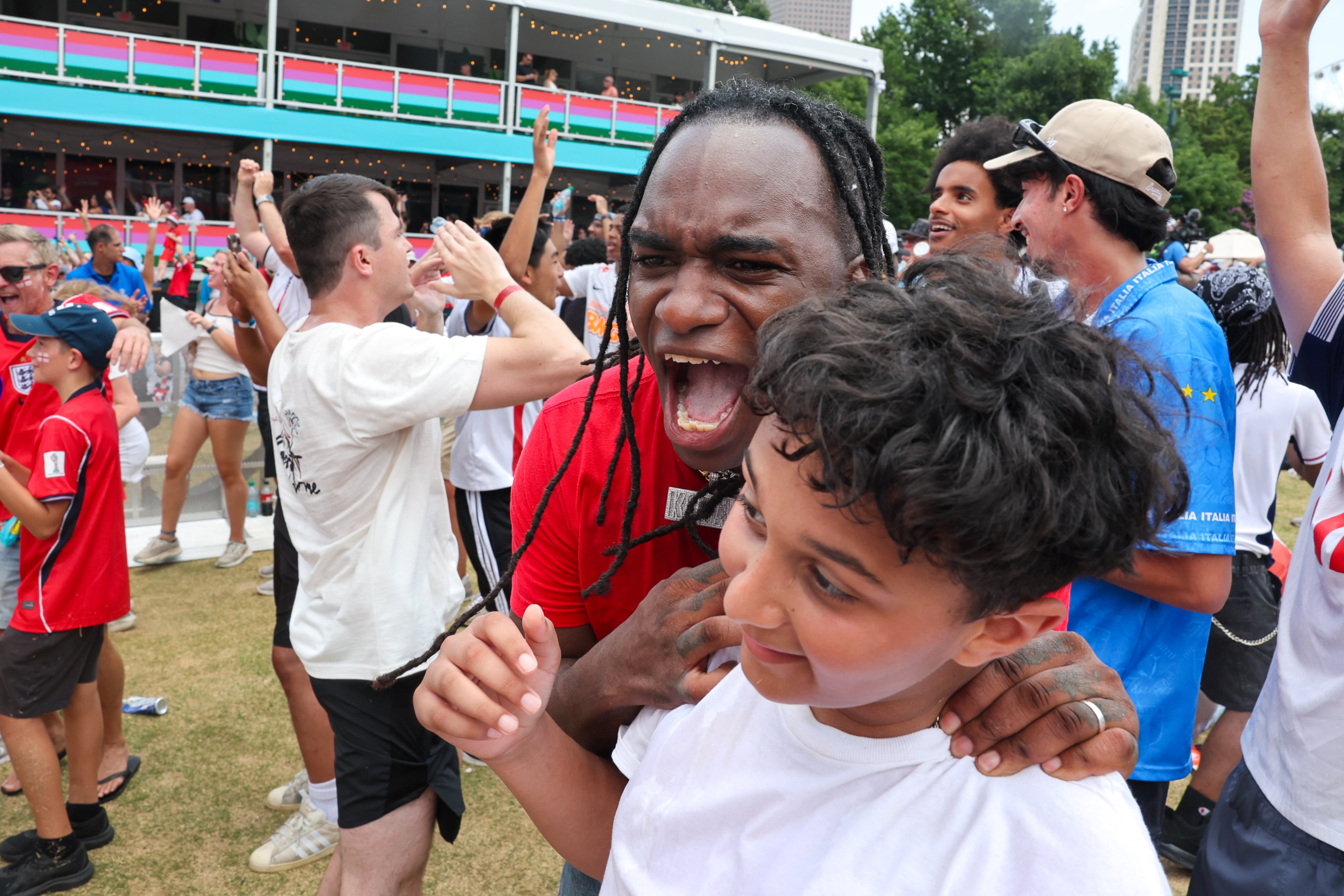 England fans celebrate their win at Fan Fest in Centennial Olympic Park in Atlanta in the second half of the England versus Congo FIFA World Cup game on July 1, 2026. The game is being played in Atlanta Stadium (Mercedes Benz Stadium) for the knockout round of 32. England won 2-1. (Arvin Temkar/AJC)